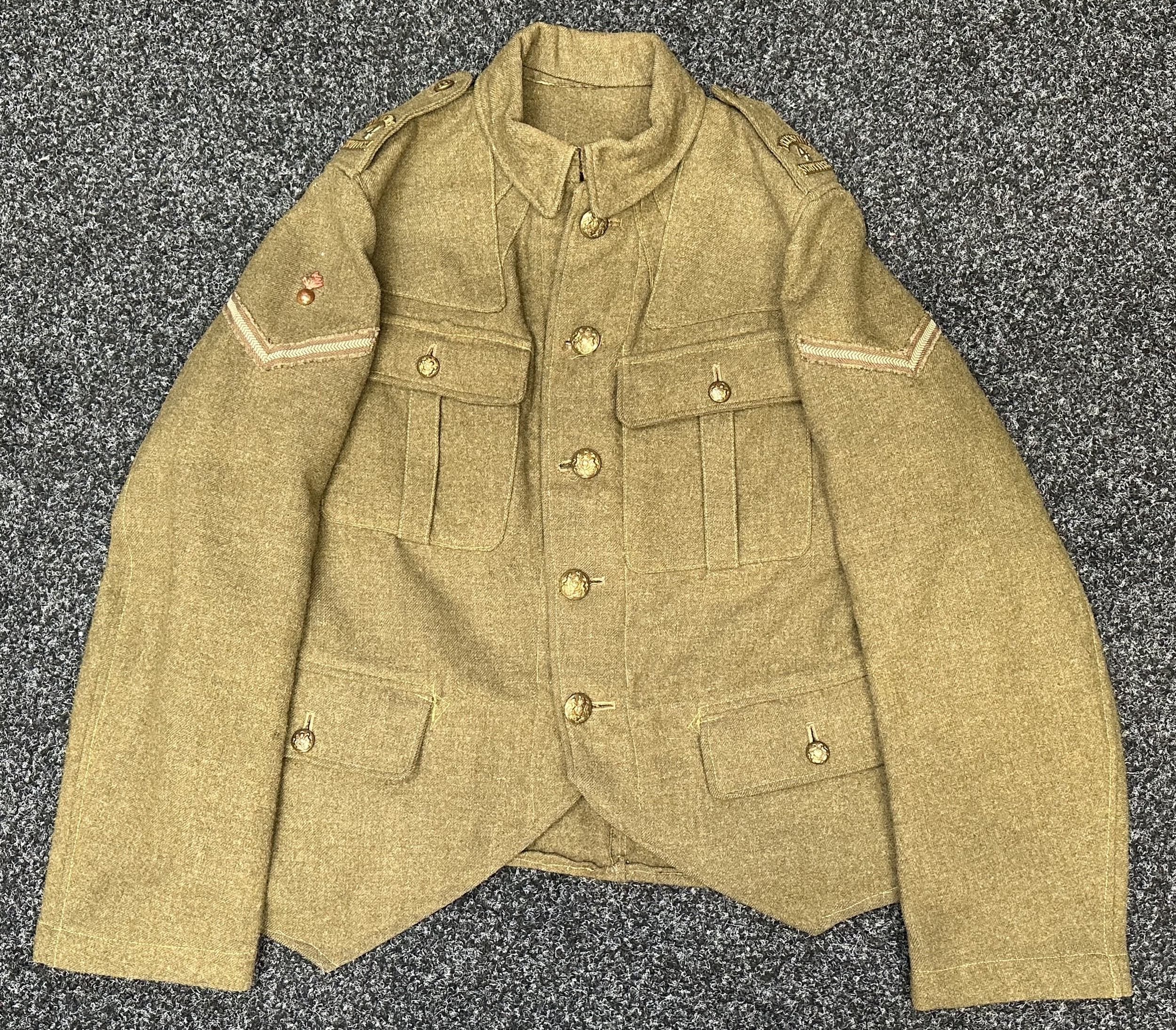 WW1 British 4th Tyneside Scottish Other Ranks Doublet Jacket with Lance Corporals Rank insignia with Brass Flaming Grenade above, war economy 4th Tyneside Scottish Brass & Nickle Shoulder titles, General Service buttons. Jacket is marked with WD Broad Arrow along with inspection codes M and 139. Has brooch pinned cap badge in the pocket along with a small peice of shell driving band shrapnel plus three NF brass shoulder titles and a flaming grenade collar dog. Has two tailor made internal breast pockets added to the inside of the jacket. Tartan flash and Victory medal ribbon iside one of the pockets.