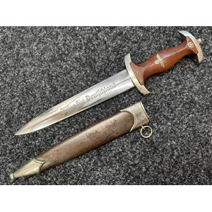 WW2 Third Reich SA Dienstdolch 1933 Pattern Dagger with double edged blade with "Alles Fur Deutschland" motto along with makers mark for "Hermann Schneider, Solingen-Aufderhone", 220mm in length. Early nickle fittings. Crossguard in SA Gruppe marked "NS" for Niedersachsen. Wooden grip complete with eagle and SA emblem. Overall length 345mm. Complete with scabbard with early annodised finish. War souvenir of a British Veteran of the 63rd Anti Tank Regiment Royal Artillery. New to the market.