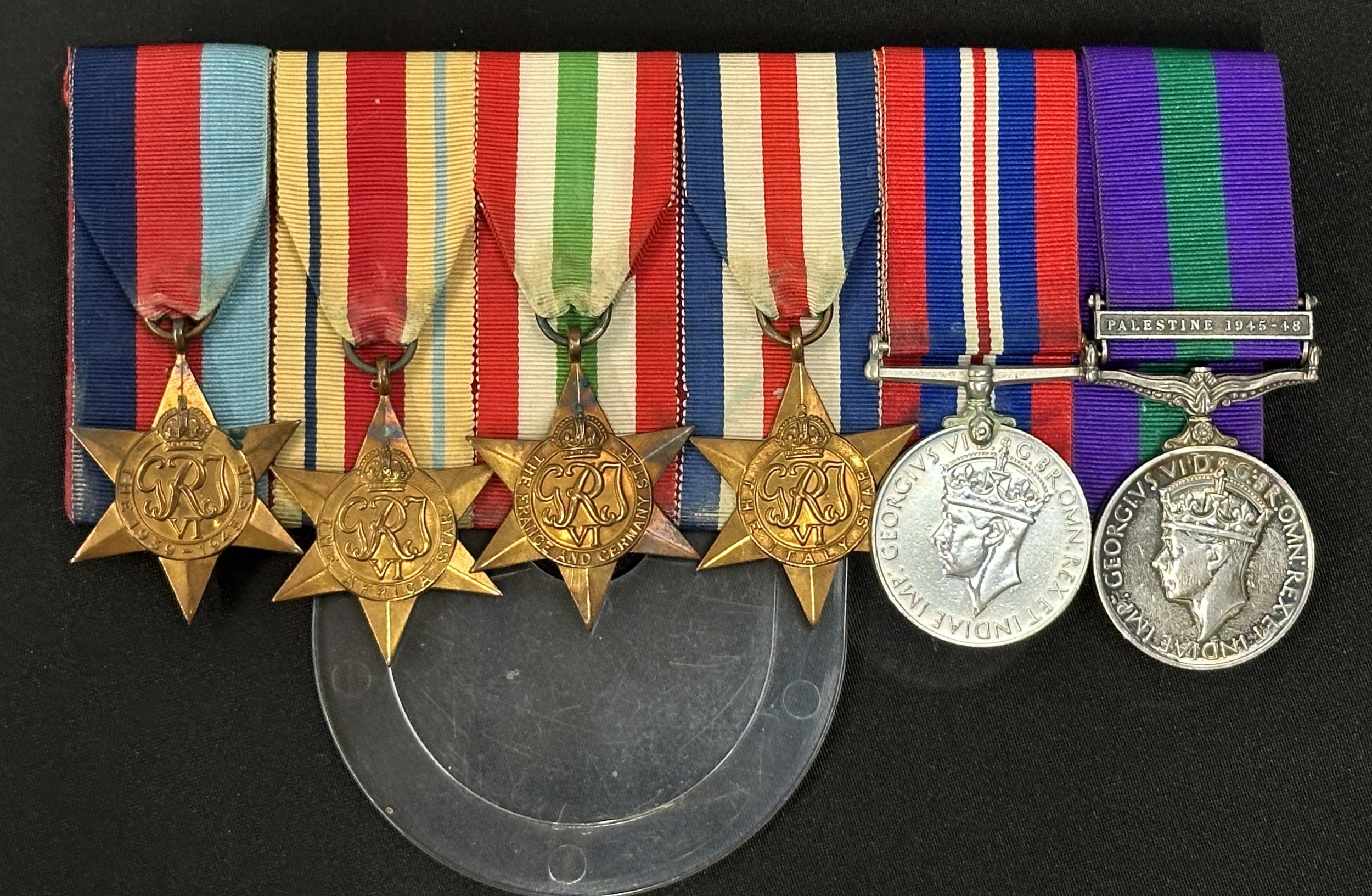 WW2 British Parachute Regiment Medal Group to Lance Corporal Fred Dix, Parachute Regt, Army Air Corps to include 1939-45 Star, Africa Star, Italy Star, France & Germany Star, War Medal and GR VI General Service Medal with Palestine Clasp 1945-48. All mounted on a bar which is named in ink on the reverse.