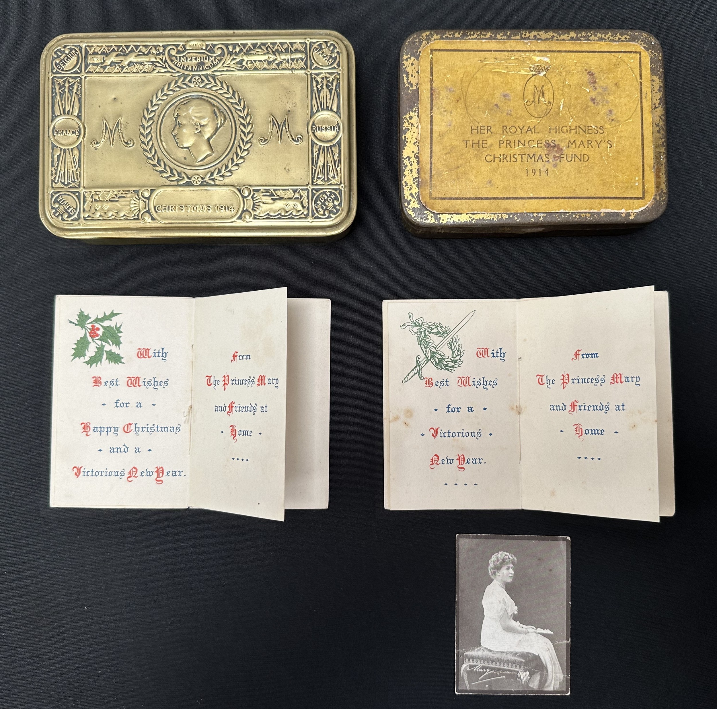 WW1 British Princess Mary's Gift Tin 1914 along with Greetings Cards for 1914 and 1915 and another tin with rare printed label stating "Her Royal Highness The Princess Mary's Christmas Fund 1914". Size of tin 105mm x 78mm.