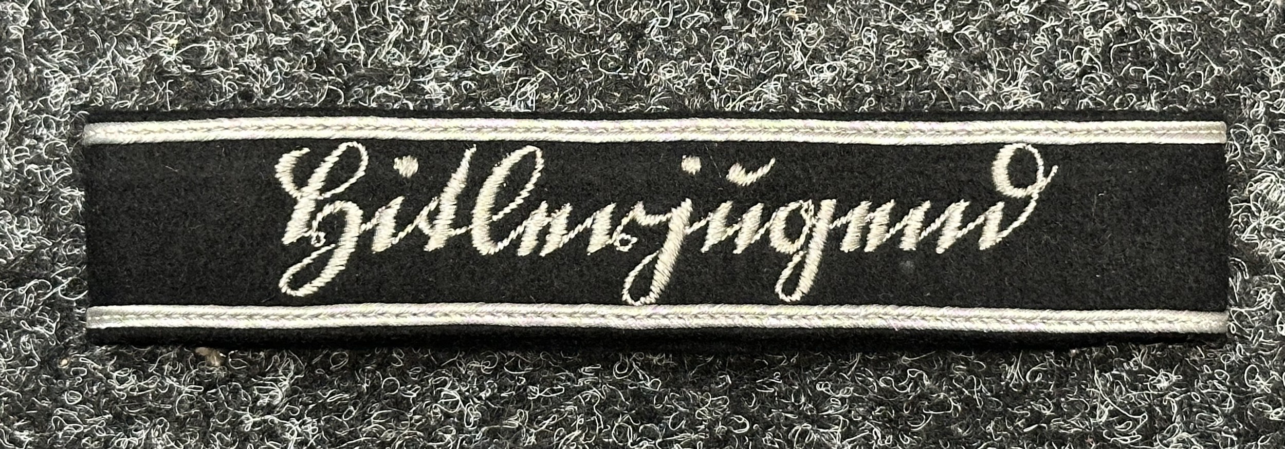 WW2 Third Reich Sutterlein "Hitlerjugend" cuff title. Uniform removed, full length and complete with RZM paper label. Worn by staff members of the Reichsfuhrung der Hitlerjugend.