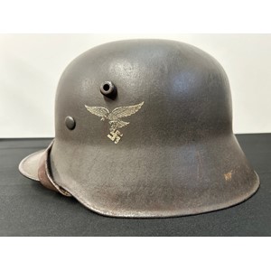 WW2 Third Reich M16 Steel Helmet, maker and size marked "N66" along with batch number "E446" to crown. Transitional period helmet fitted with early pattern M35 alloy liner band with square bales, leather liner and chinstrap. Note: Luftwaffe early pattern droop tail eagle and National colours decals are not original.