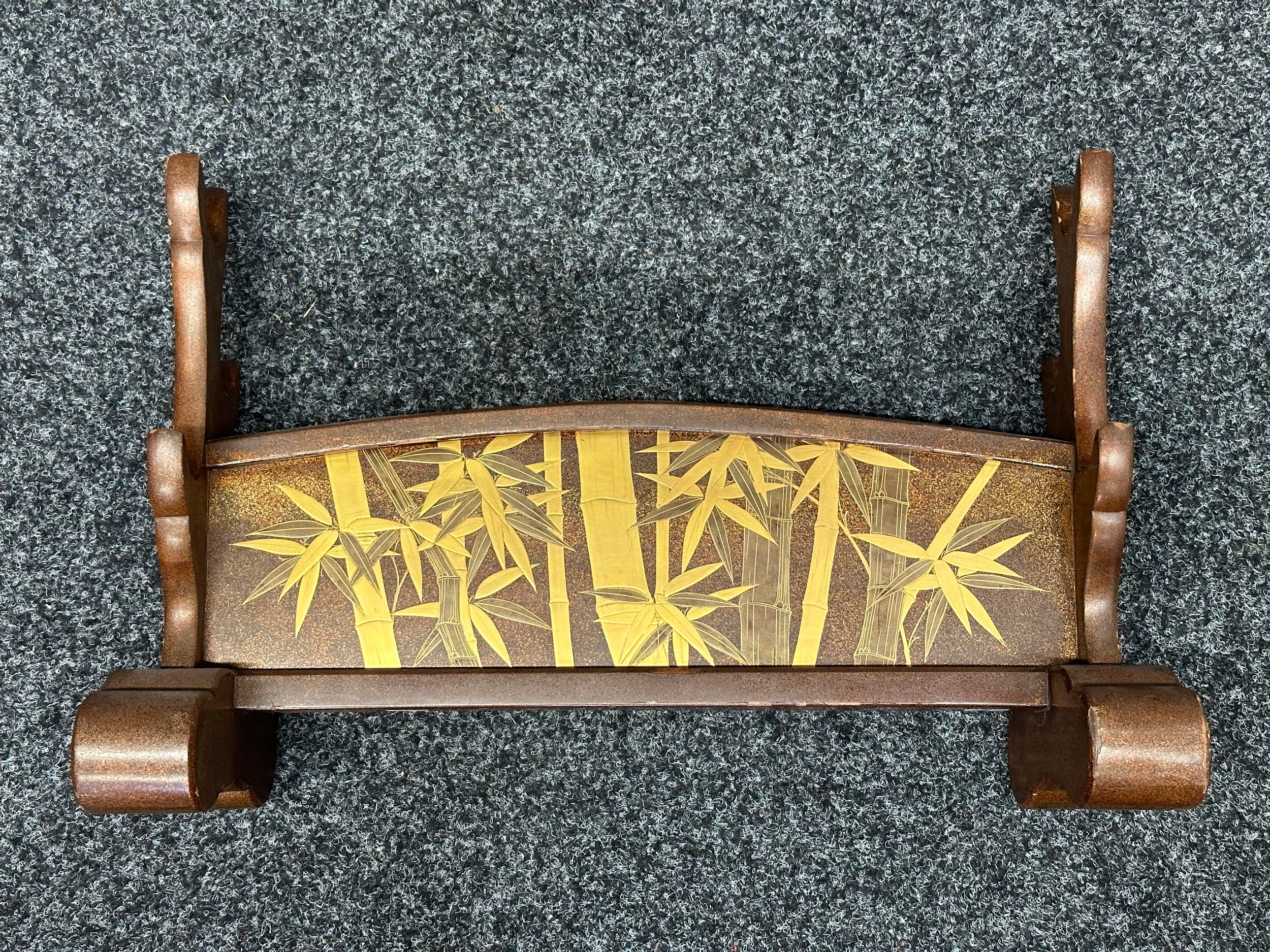 Japanese Sword Stand for three swords. Wooden. Decorated with gilt Bamboo designs. Height 34.5cc, width 53cm, depth 19cm.