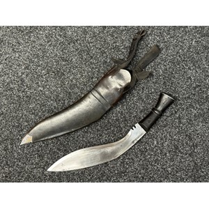 A rare British MKIV Pattern Kukri knife, with 300mm long blade maker marked and dated "WSC 51" (Wilkinson Sword Co 1951). Black ebonised wooden grip. Overall length 420mm.  Complete with black leather scabbard with metal chape. Scabbard contains both small knives, again marked "WSC51". Complete with it's frog which has two straps to secure to the belt. Only 1,400 examples of these were ever made and it is the rarest British military issue Kukri knife.