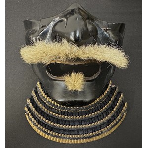 Japanese Samurai Menpo or Me no shita Facial Armour. Black laquered finish with gilt decoration and hair moustache. Multi part construction.  Shikoro neck guard. No markings.