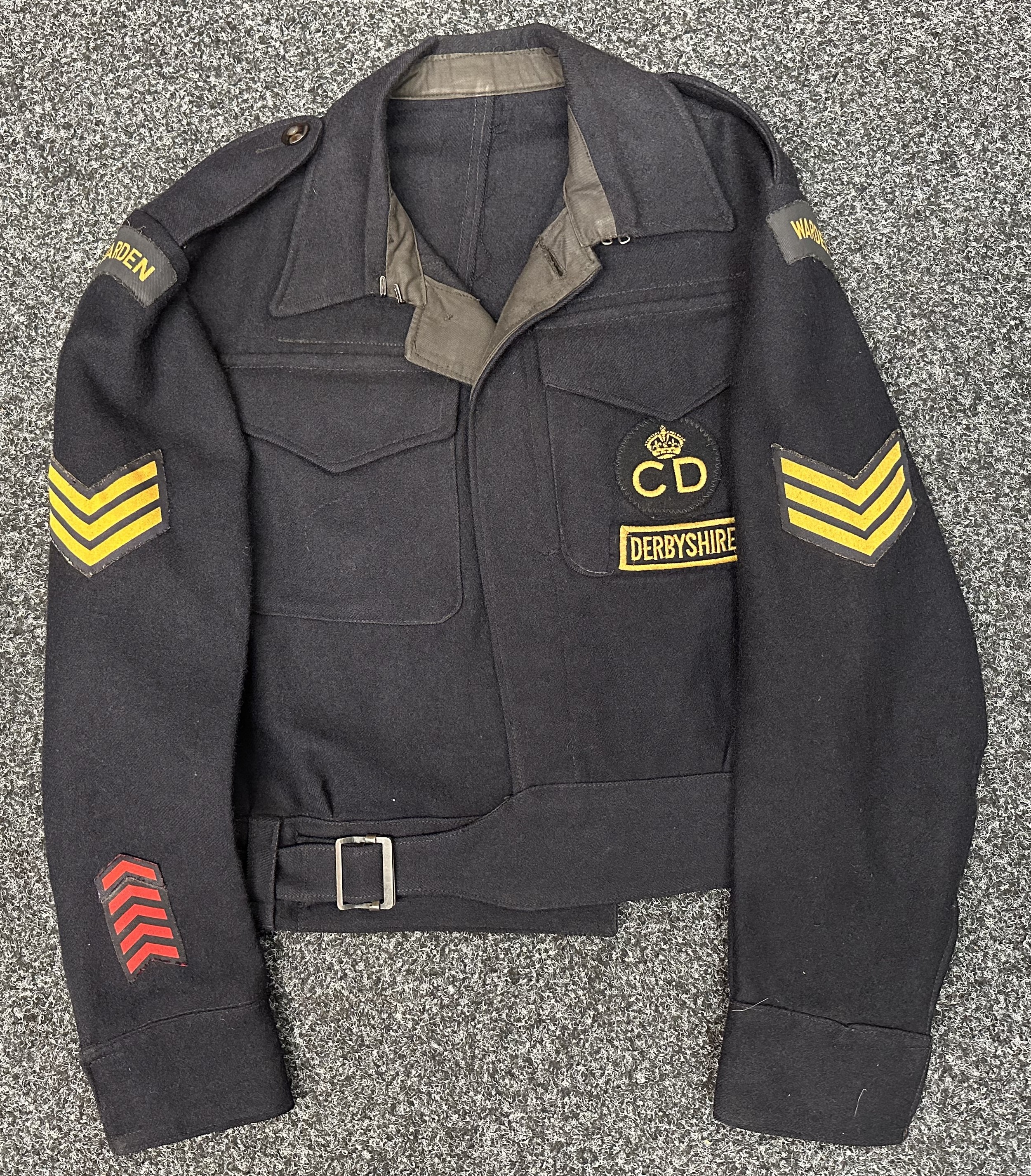 WW2 Blouse ARP 57 with printed Warden shoulder titles. Printed Sgt's stripes to sleeves. Embroidered "Kings Crown CD" and "Derbyshire" badges to breast pocket. Five red service chrevons to cuff. Makers Label "Prices Tailors Limited proprietors of the 50 Shilling Tailors". Size 6. WD Inspection mark to lining with code letter O. Letter found in pocket dated 30/7/44.