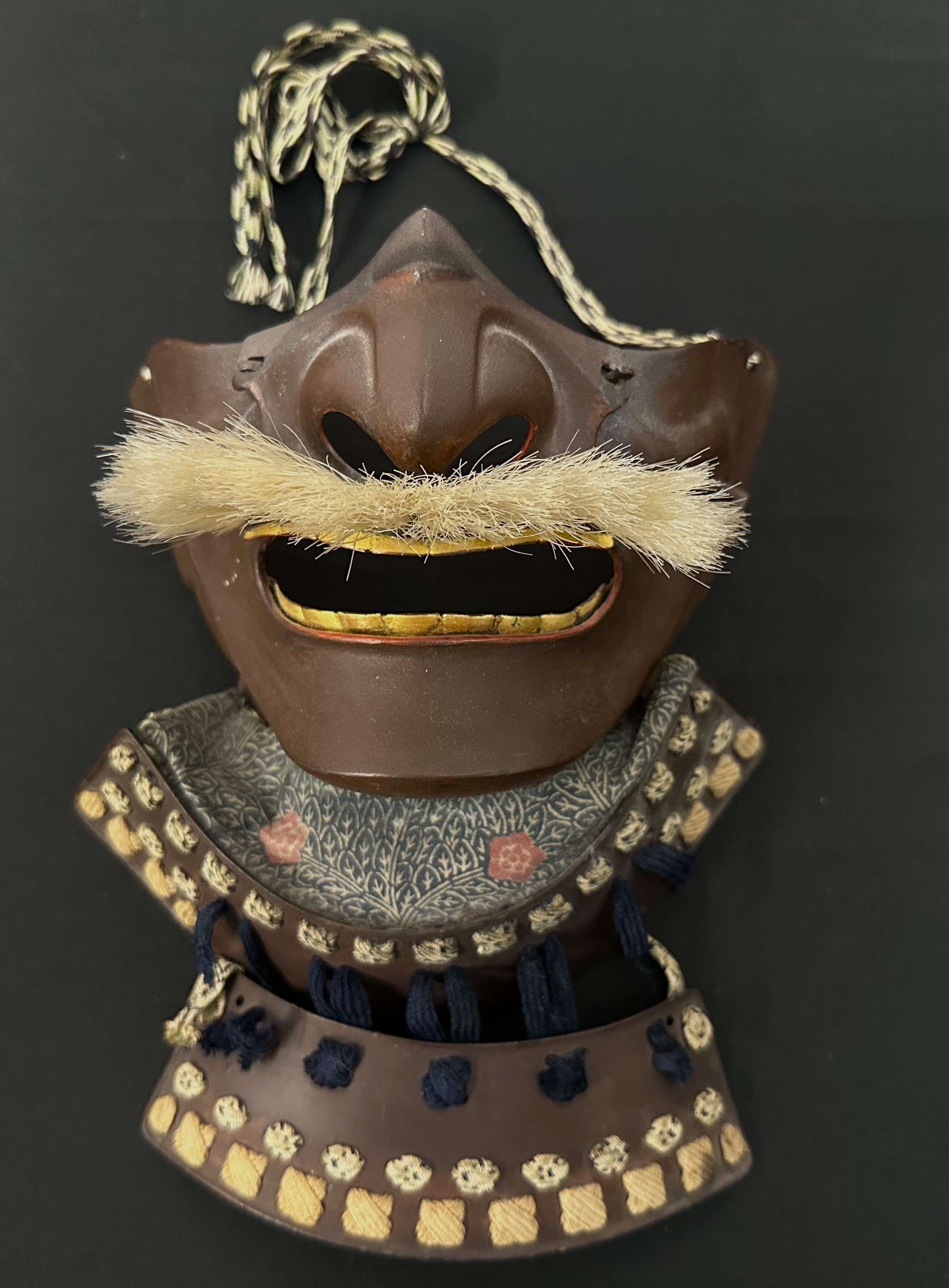 Japanese Samurai Menpo or Me no shita ho facial armour with brown lacquer finish and bristle moustache and complete with Shikoro neck guards.