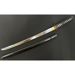Japanese Wakizashi Sword with single edged blade 540mm in length. Hamon line to cutting edge. Some chips to edge of blade. Tang is signed. Copper plated habaki. Black Tsuba with gilt and silver decoration which is unsigned. Samegawa Shagreen Ray Skin grip with black Tsuka-ito cloth binding with Menuki present. Overall length 725mm. Complete with dark brown laquered finish Saya scabbard.