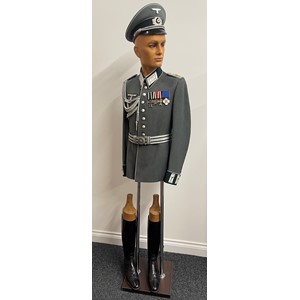 WW2 Third Reich Heer Infanterie Officers Waffenrock for Reserve Infantry Regt 74, rank of Oberleutnant. Named to "Herr Brugggemann" and with makers label for "Friedr. Hesemann, Hannover". Dated 11/7/38. Complete with Officers aiguillettes. White Infantry piped Officers Schirmmutze which is maker marked "L.Lulf & Sohn, Bad - Mergentheim" along with "Stirndruckfrei Deutsches Reichspatent". Officers Brocade Parade Belt and buckle, no makers markings, size 85, Jackboots and decorations consisting of EKII 1914, Cross of Honour with Swords, War Merit Cross 2nd class without Swords, 25 Year Faithful Service Cross all mounted on a bar. All displayed on a mannequin torso which is included in this lot.