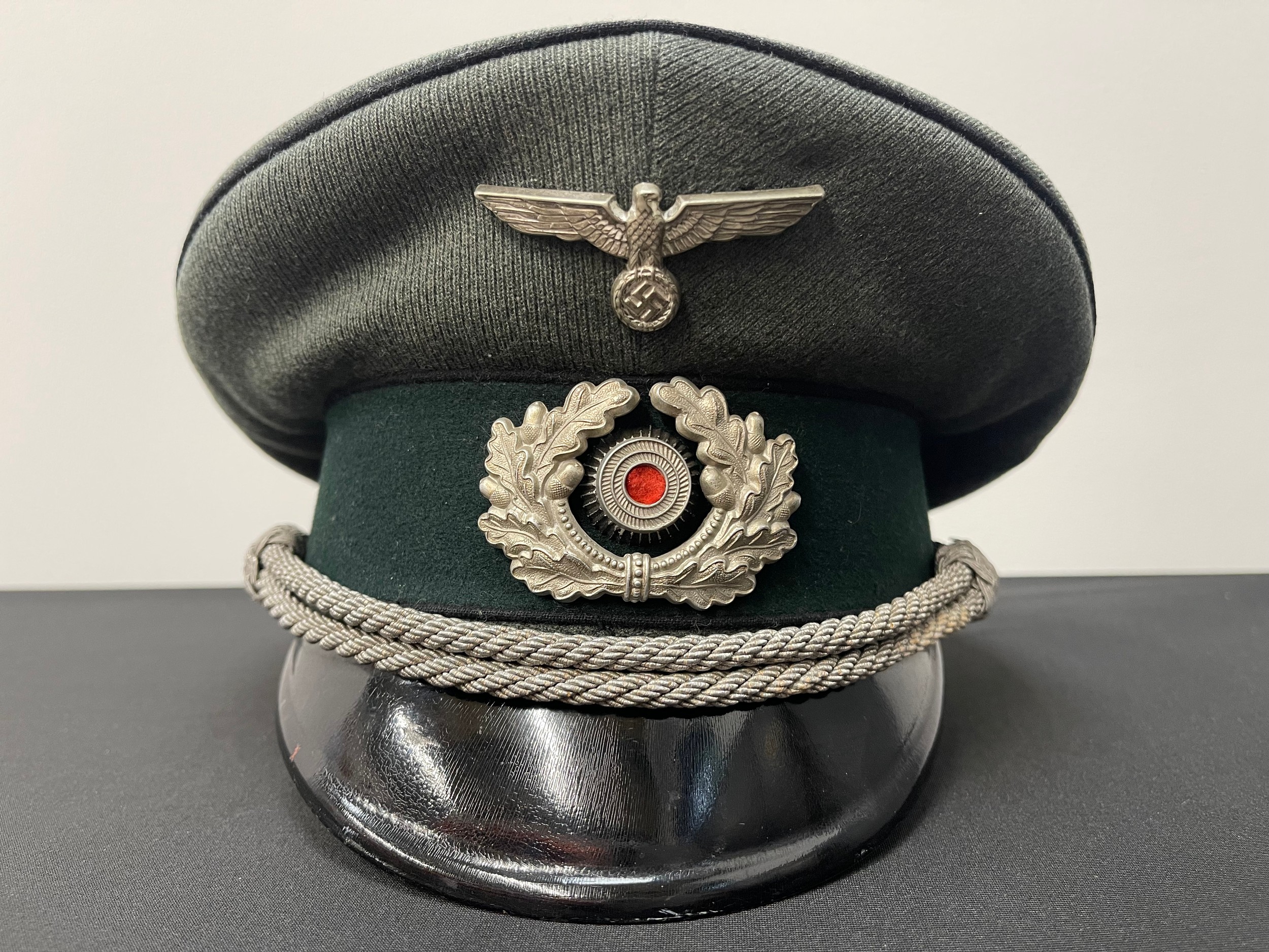 WW2 Third Reich Heer Pioneer Officers Schirmmutze cap. Trikot material. This is an enlisted mans or NCO's cap which as been upgraded with Officers buttons and chinstrap. Size 55. Cap spring in place.