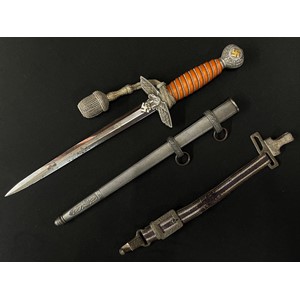 WW2 Third Reich 2nd Pattern Luftwaffe Dienstdolch Officers Dagger with 250mm long double edged blade maker marked "Original Eickhorn, Solingen". Orange Trolon wire bound grip. Pommel retains original gilding to the swastika. Overall length 387mm. Complete with original knot and scabbard. Also has the remains of the hanger. New to the market, war souvenir of a member of the British Army who traded cigarettes for the dagger in Germany in 1945.