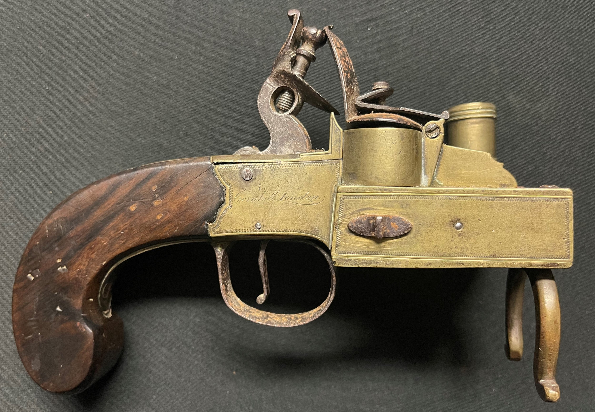 GRIII Flintlock Tinder Lighter with brass body signed "Cornhill, London" along with "P-Bond". Holds at both full and half cocked positions. Overall length 180mm. Height 123mm.