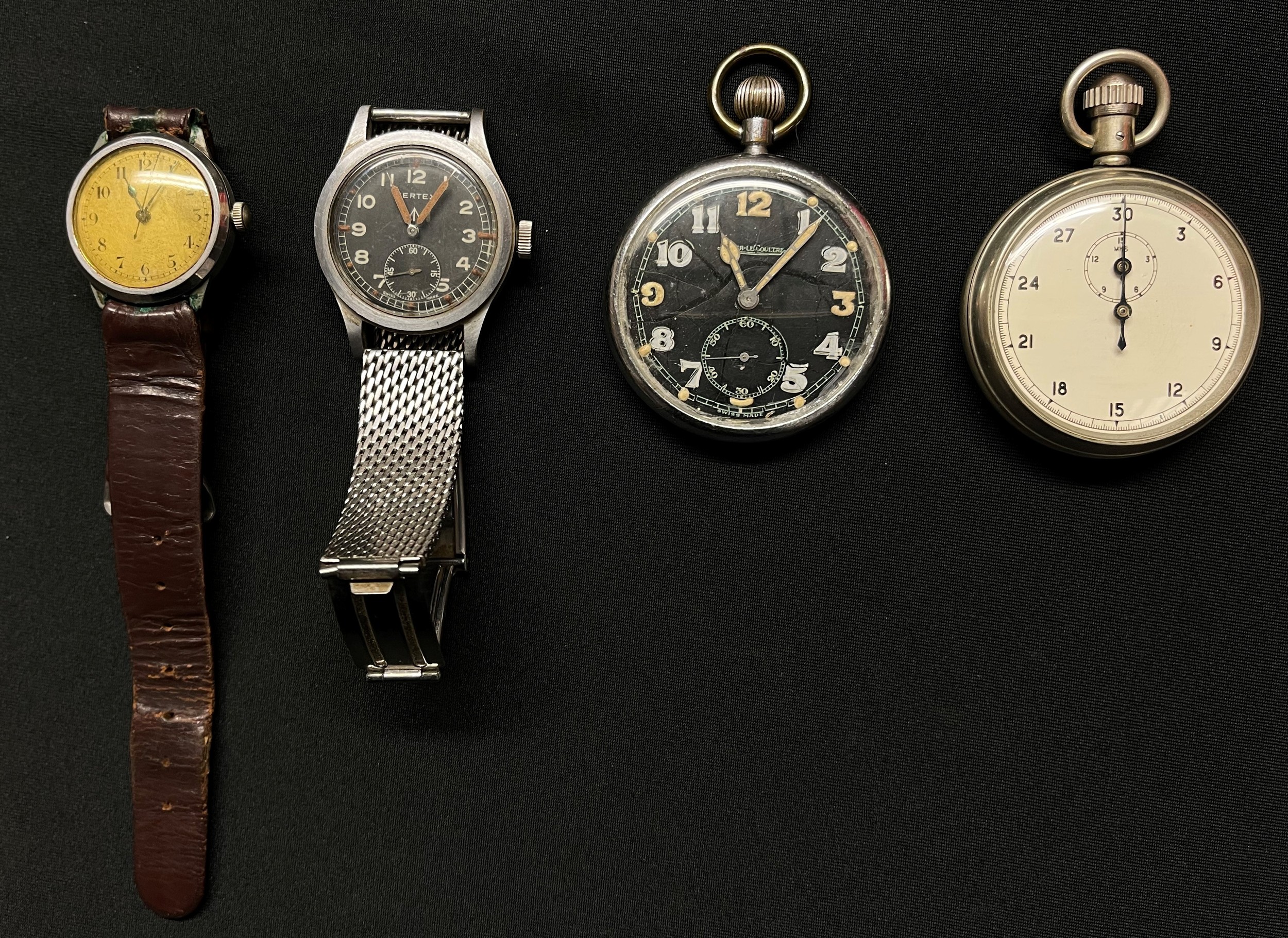 WW2 British Watch collection to include: Watch, Wrist, Waterproof by Vertex. One of the so called "Dirty Dozen". Reverse of case marked WWW along with WD Broad Arrow, serialnumbered "A13626" and "3526544". Does not run. Non original strap: WW2 British GSTP Jager Le Coultre pocket watch case marked with WD Borad Arrow along with "GSTP" and serial number "F009979", Black dial with Arabic numerals, separate seconds dial (Runs and ticks would recommend a clean & service) : WW2 British Stopwatch by Dennison marked on reverse of case "1/10 Sec VC/2534" along with serial number "11534" WD Broad Arrow and "161". Runs and ticks would recommend a clean and service: WW2 British RAF Wristwatch marked on reverse of case "AM 14.A/1102" along with "21722" Does not run. (4)
