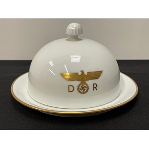WW2 Third Reich Hermann Göring Nymphenburg Porcelain Domed Lidded Butter Dish From His Personal Deutsche Reichsbahn train Sonderzug "Asien" carriage number 10 205. Centered to the main body of the lid is the Deutsche Reichsbahn insignia of a gold eagle and swastika flanked by the letters D and R. To the underside of the dish is found the green Nymphenburg crest, an impressed Nymphenburg shield and a small inscribed  hand-painted number ‘205’ in black indicating the wagon number. Dish is 350mm in diameter. Overall height 84mm with lid in place.