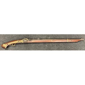 Japanese Samurai Matchlock Musket with decorated octagonal barrel 767mm in length. Bore approx. 12mm. Decorated with Swallows in flight. Brass barrel band. Working action. Brass lock, trigger guard and cherry blossom stock decoration along with brass Shisa dog (Fu lion) to butt. Japanese markings to lock and to brass plate on butt. Overall length 107cm. No ramrod. Section 58 (2) No licence required in the UK.