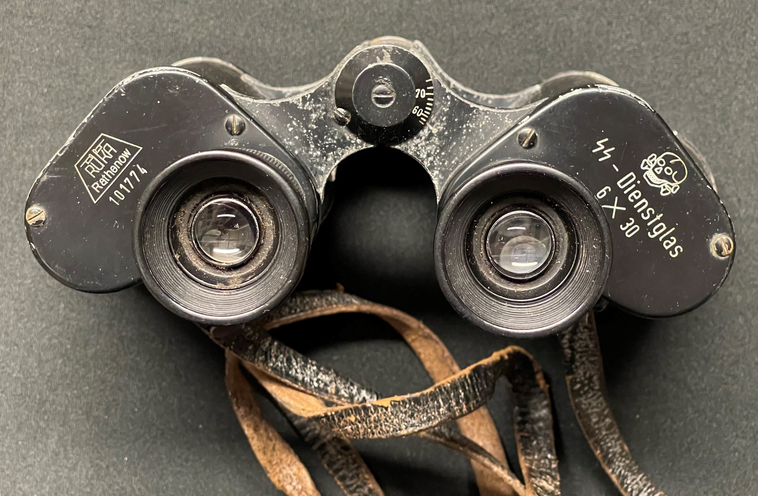 WW2 Third Reich Rare Waffen SS issue 6x30 Dienstglas Binoculars maker RUKA Rathenow, serial number 101774. Complete with original leather neck strap, black bakelite case and bakelite lens covers.