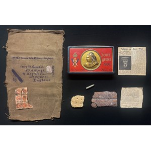 Boer War interest: Queen Victoria's South Africa 1900 Gift Tin which was issued to 3418 Pte Robert Sewell, 2nd Devons. He posted the tin home from Ladysmith to his wife wrapped in a khaki cloth cover. The tin has inside it two bars of the original Rowntrees chocolate and a biscuit in addition to a Boer bullet which struck Pte Sewells belt at the Battle of Colenso in 1899. There is also a Newspaper cutting citing a letter about the tin and contents written by Mr Sewell plus another newspaper cutting with his Obitury.
