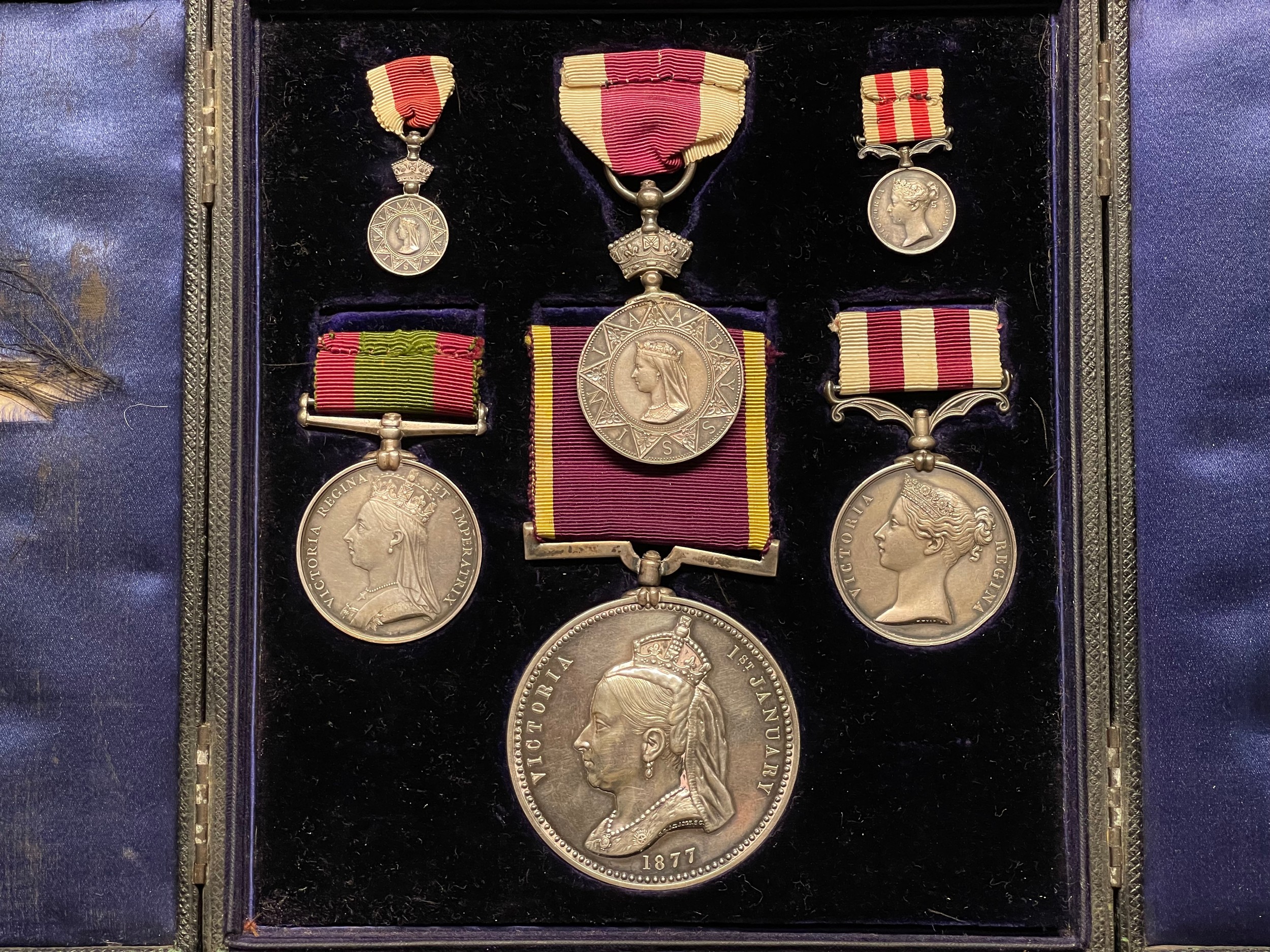 Medal Group to Major A England, X Bengal Lancers comprising of Indian Mutiny Medal, Abyssinian War Medal, Afganistan Medal 1878-79-80, Empress of India Medal 1877. Along with miniatures of the Abyssinian and Afganistan medals. All complete with original ribbon an housed is a period fitted display case. NOTE: Major England's sword is also included as lot 3091 in this sale.
