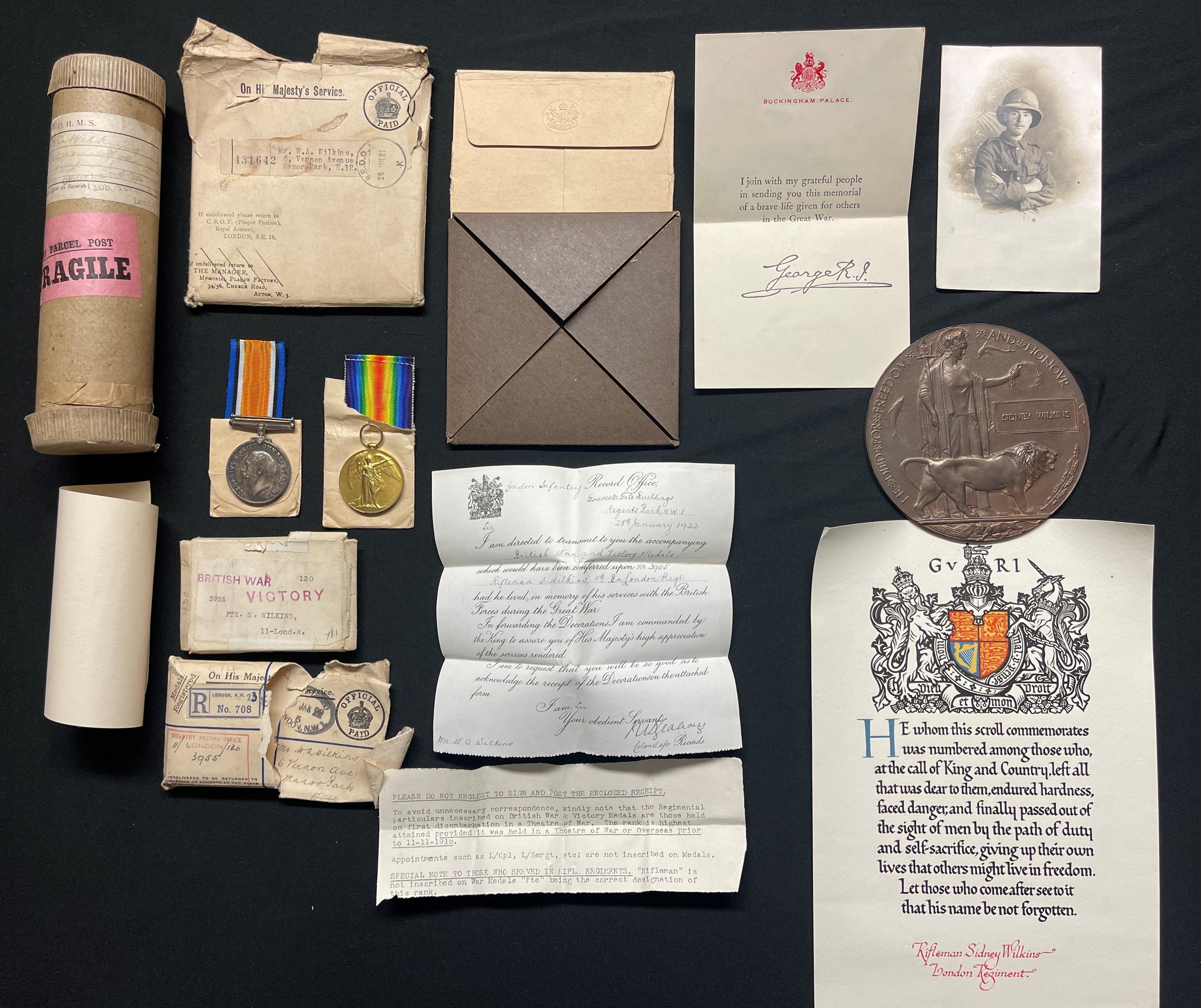 WW1 British London Regiment Death Plaque Group to 3955 Pte Sidney Wilkins, 11th Battl London Regt (Finsbury Rifles) comprising of: Death Plaque in original card cover with postage cover, Scroll in original carboard postage tube with Kings letter, War Medal and Victory Medal in original packets with ribbons and envelope along with a portrait photograph of Rifleman Wilkins. KIA 11th April 1917. New to the market.