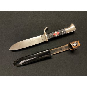WW2 Third Reich Hitler Youth Knife with single edged blade 135mm in length, with "Blut Und Ehre!" and  transitional maker marked with "Kletterman & Moog" and "RZM M7/29 1937". Black Bakelite grip inset with enamel HJ insignia. Overall length 245mm. Leather hanger with retaining loop and press stud. Original black enamel painted finish to scabbard.