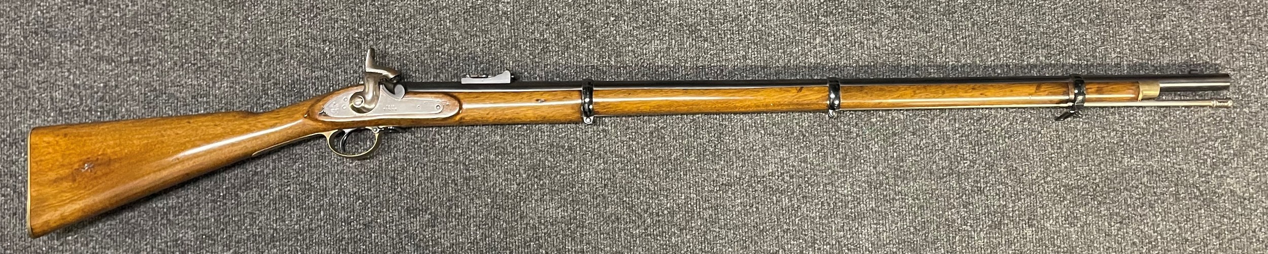 3 Band Enfield Tower Pattern Musket 1858. 980mm long barrel. Overall length 140.5cm. Bore approx. 15mm. Complete with ramrod. Working action which holds at both full and half cock. Brass but plate with marking to the Bolton Volunteers. Inspection marks to stock. Professionally restored condition. Note: Section 58 (2) No licence required in the UK.
