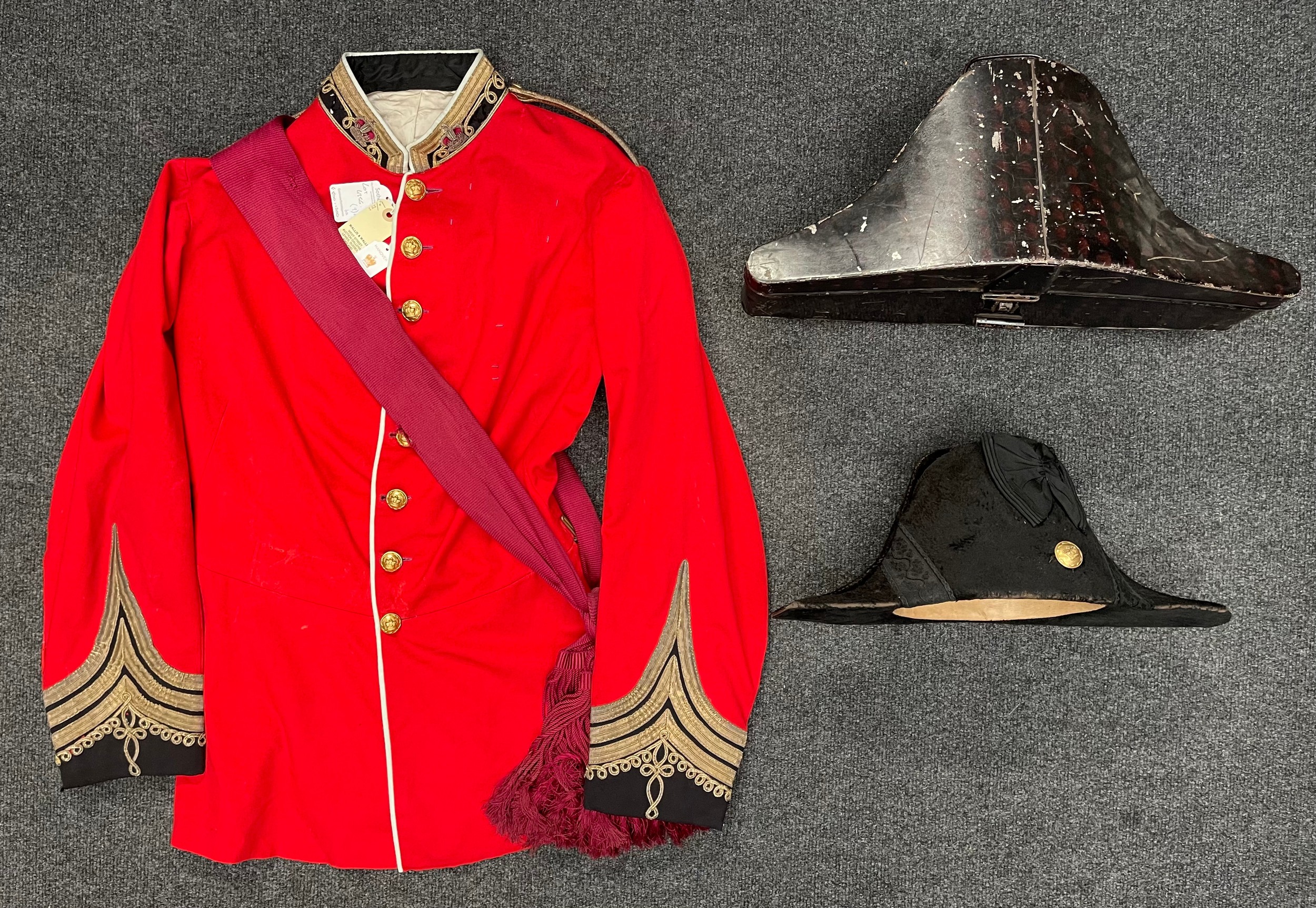 Uniform of a Colonel on the Un-Attached list, worn by Prince Ernest Augustus, circa 1878. Prince Ernest Augustus of Hanover, Duke of Brunswick-Lüneburg, Prince of Great Britain and Ireland: Fore and Aft Hat maker marked "Cater & Co. 56, Pall Mall, London" complete with original transit tin and his Scarlet Full Dress Tunic with crimson silk sash. The tunic has loops for his awards in place. As worn by Ernest Augustus II, 3rd Duke of Cumberland during his visit to the Prince of Wales in 1878 where he met his future wife, the then Princess of Denmark. Comes with the previous lot labels from Sotherbys and Wallis and Wallis.