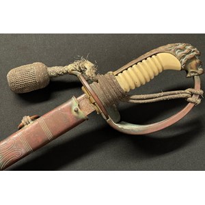 WW2 Third Reich Kreigsmarine Officers Lion Head Sword with pipe backed blade 695mm in length. Maker marked "WKC". Felt washer present. Folding guard marked with Eagle M inspection mark along with N1966. White celluloid grip, missing grip wire. Lions Head Pommel. Complete with original knot. Overall length 830mm. Complete with leather scabbard with matching numbers, brass fittings and twin suspension rings.