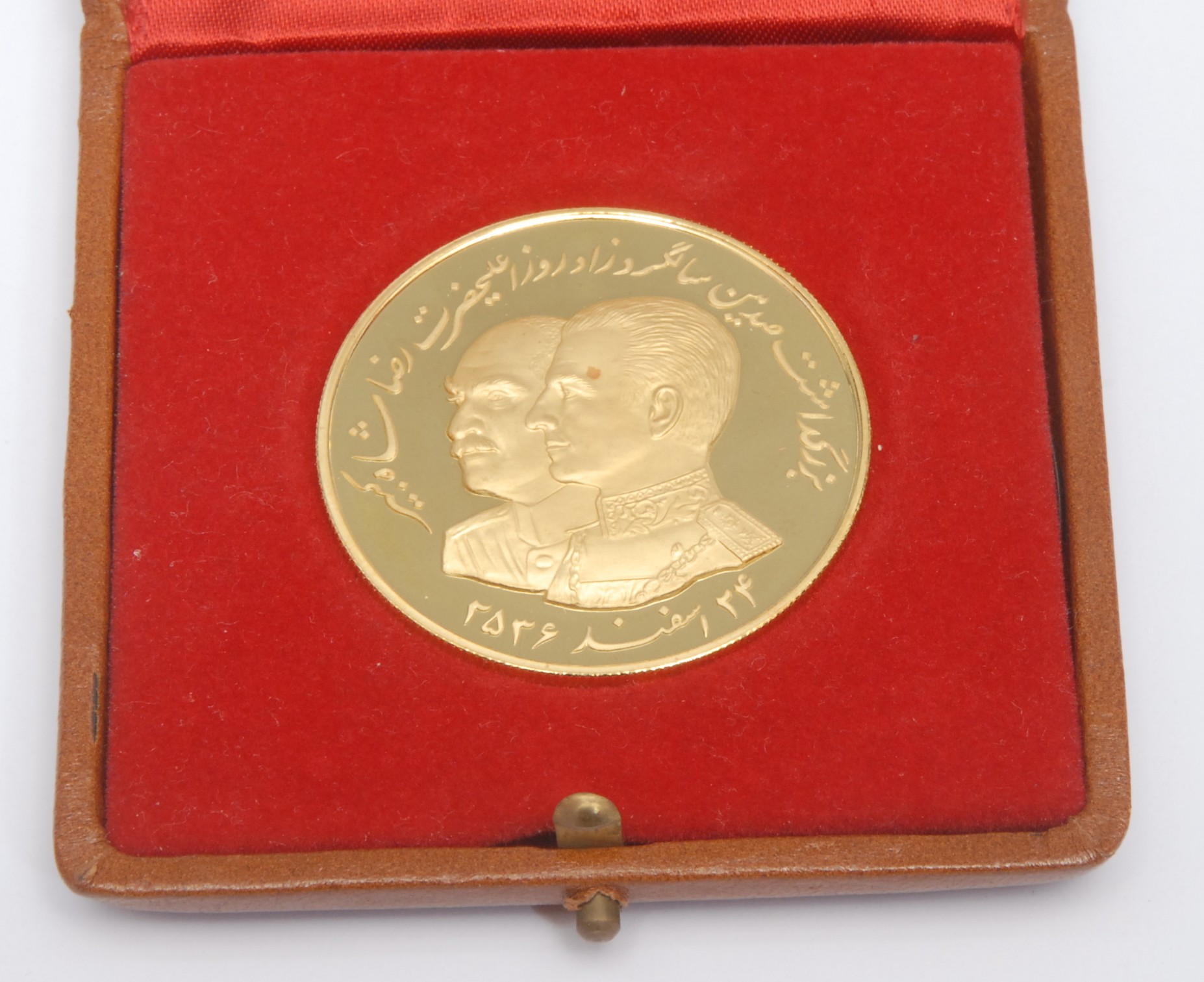 An Iranian 22ct gold coin, The 100 Years Birthday of Reza Shah The Great, Iranian date 2536, "This is the first building of Bank Meli, opened by Reza Shah" with building to obverse, 40mm, 30g, plastic sleeve, boxed