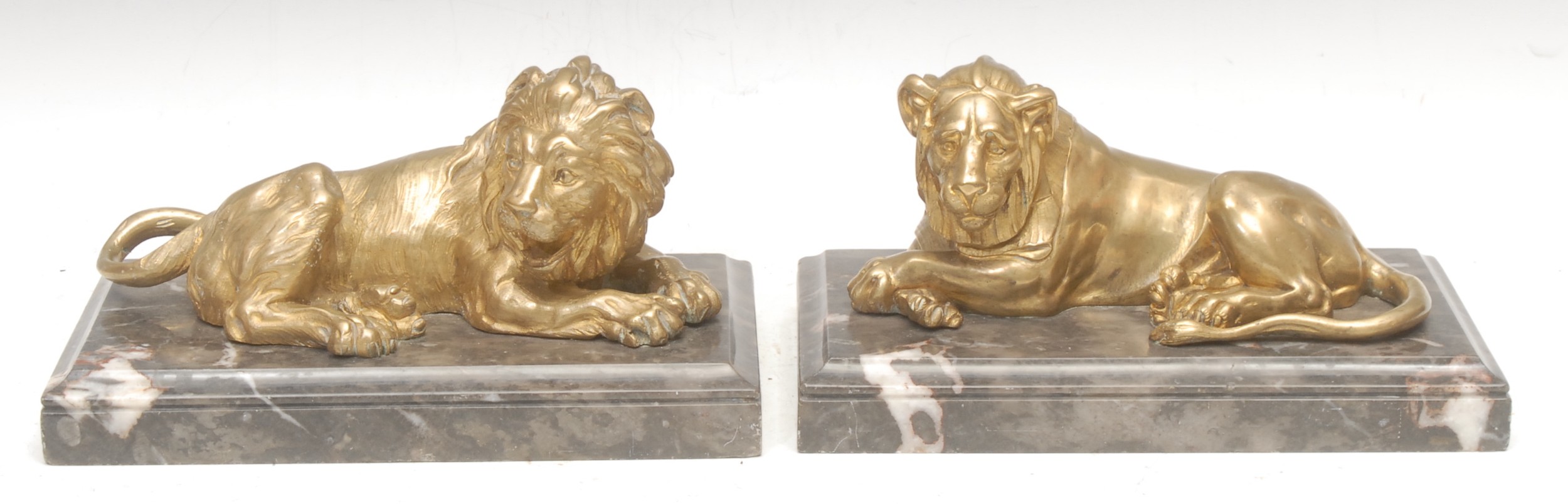 Italian School (early 20th century), a pair of figural gilt bronzes, Lion and Lioness, after the Lions of Nectanebo, in the Grand Tour Manner, veined marble moulded rectangular bases, the lion 12cm high, 24cm long overall