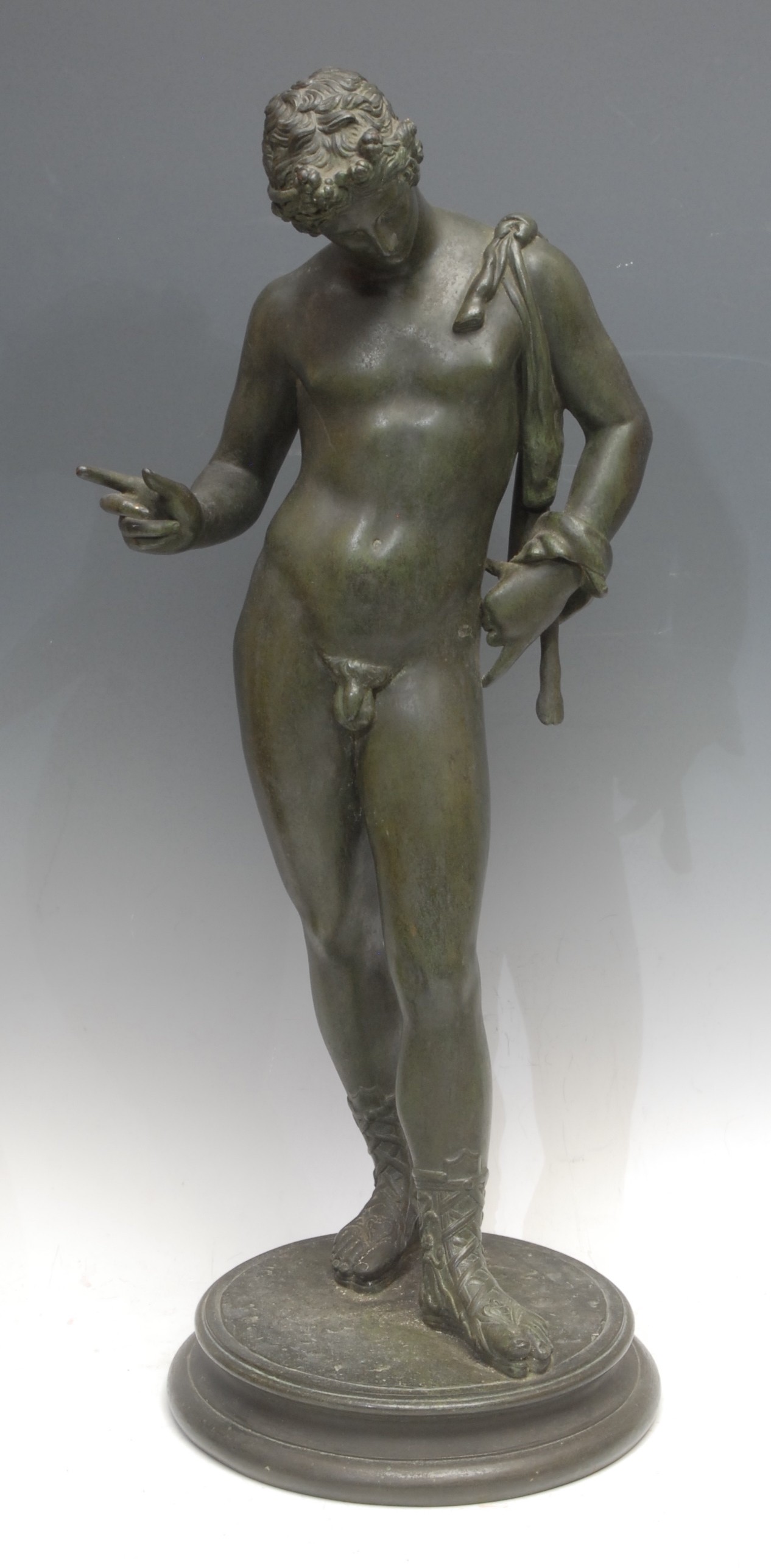 A Continental verdigris bronze effect sculpture, Dionysus, called Narcissus, in the Grand Tour manner, he stands in the contrapposto pose after the Pompeiian, socle base, 61cm high overall