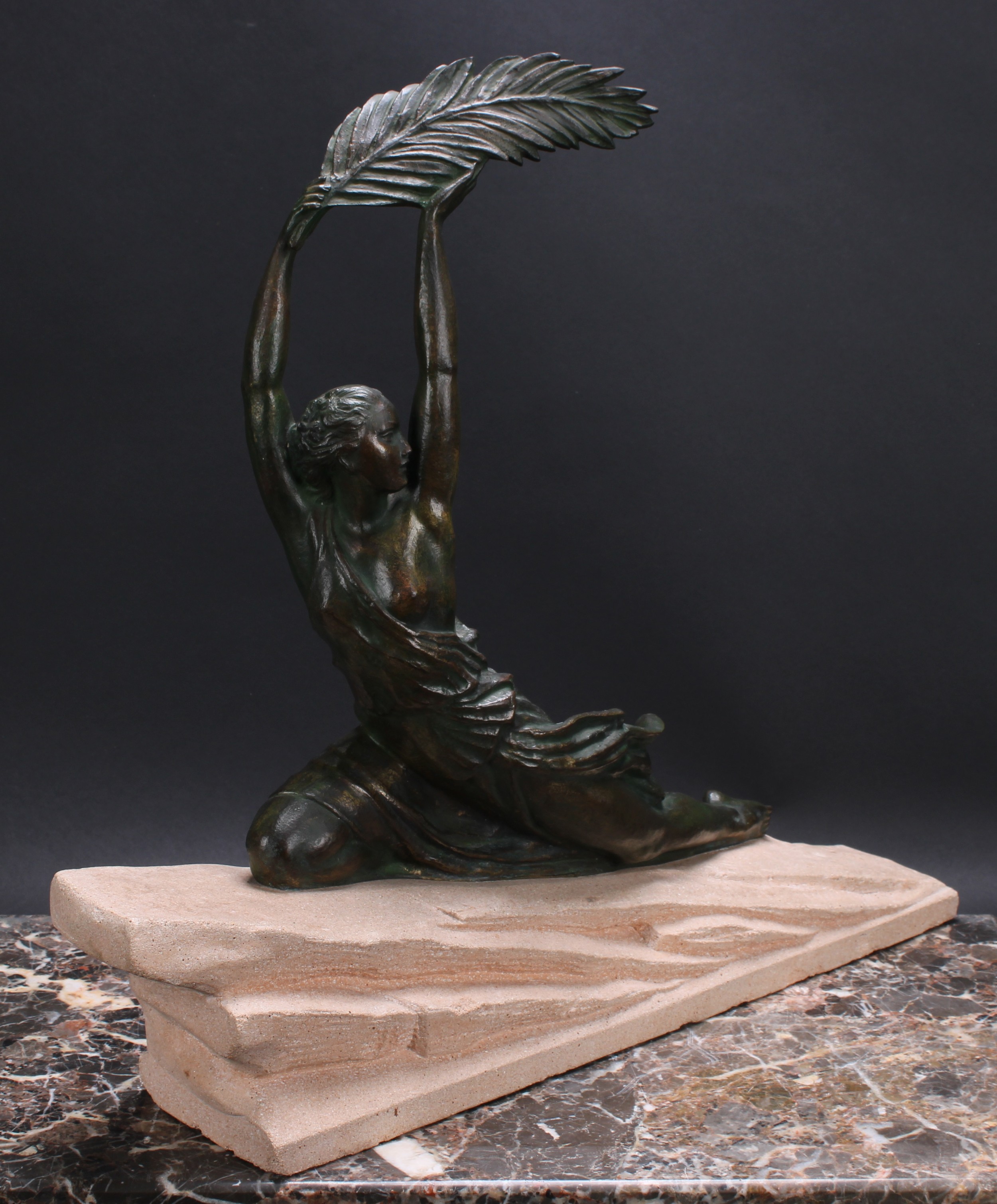 LE FAGUAYS, PIERRE (1862 - 1962)  Triomphe, an Art Deco patinated bronze, female figure, semi-clad holding aloft a single laurel leaf, kneeling upon a rocky sandstone outcrop, 49cm high, signed Fayral in the maquette, c.1920