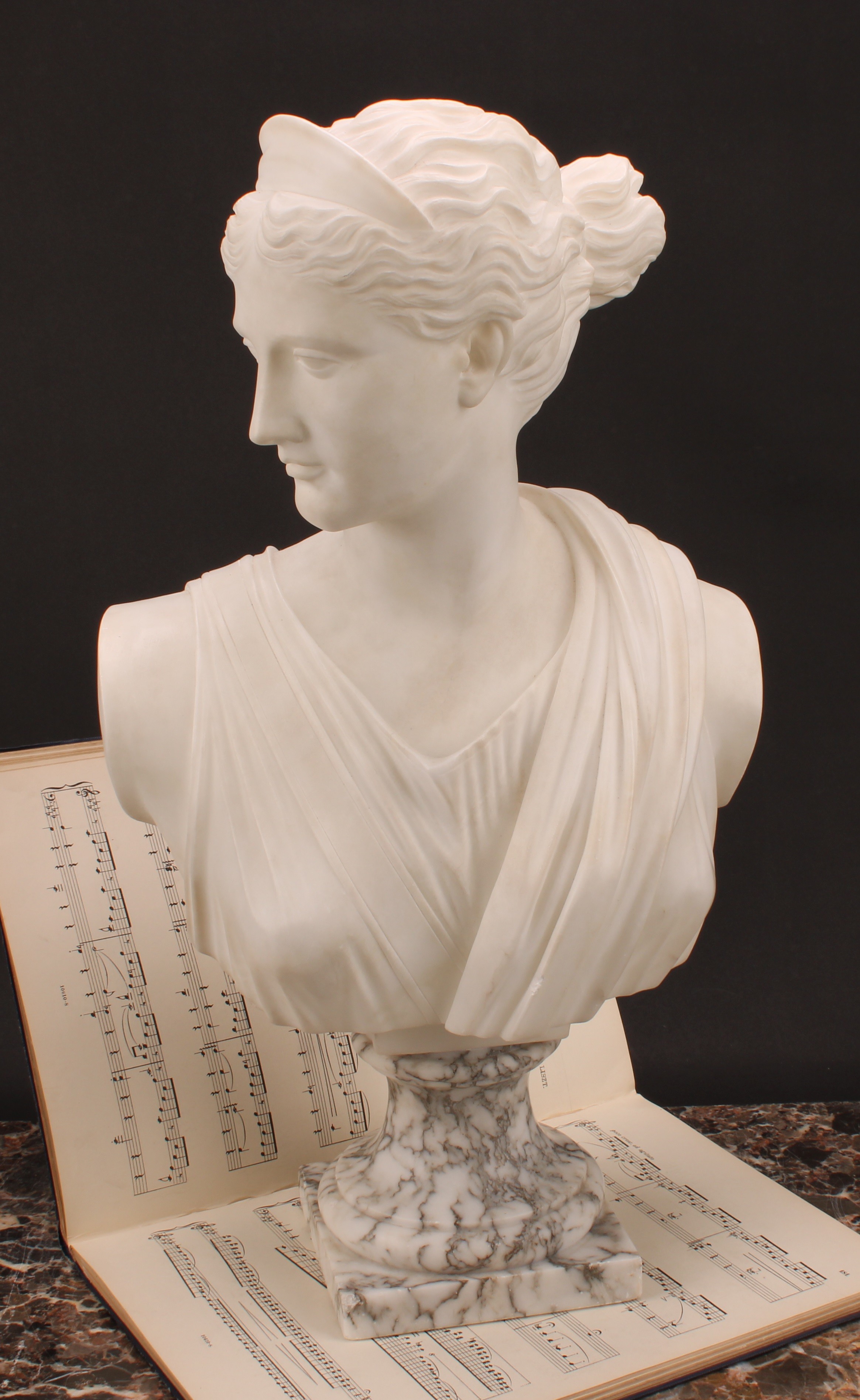 Italian School (20th century), a marble bust, of Diana the Huntress, after the Ancient Greek Leochares (c. 325 BC), on a marble base, 54.5cm high overall