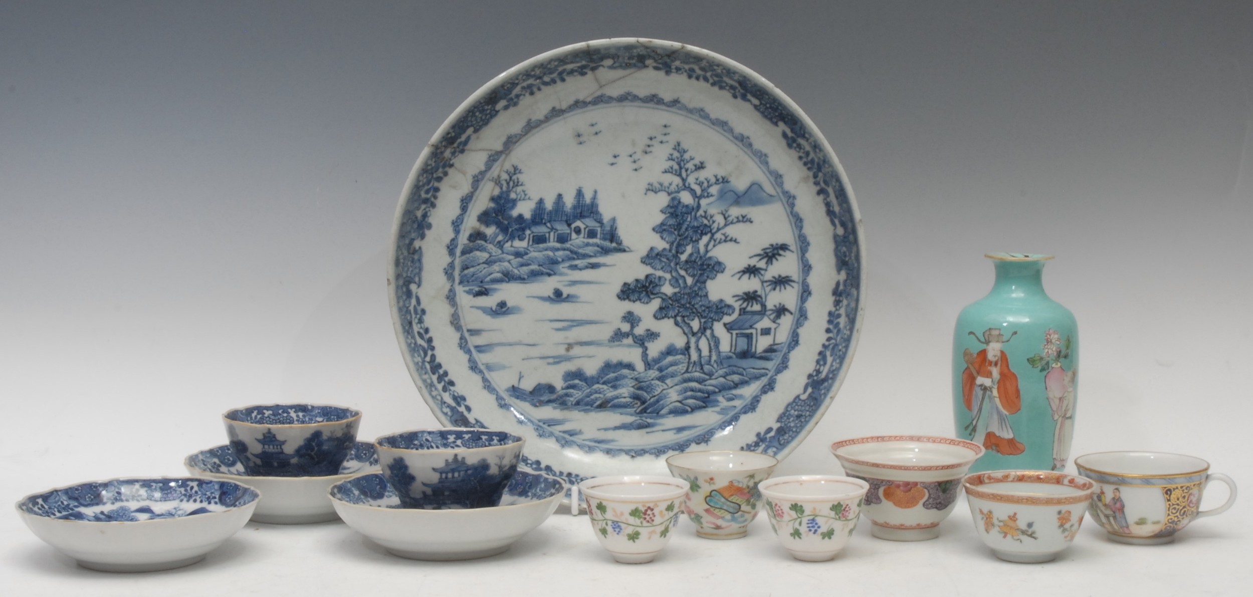 Oriental - an 18th century Chinese circular dish, decorated in tones of underglaze blue, with riverside scene, 17.5cm diameter; a Chinese export-ware tea bowl, painted in polychrome with flowers and trophies, picked out in gilt, bearing crest, 4cm high; a pair of 18th century tea bowls and stands, painted in underglaze blue, with riverside scene; other Chinese tea bowls; a Chinese ovoid vase, decorated with figures, on a turquoise ground, 14cm high; etc, qty