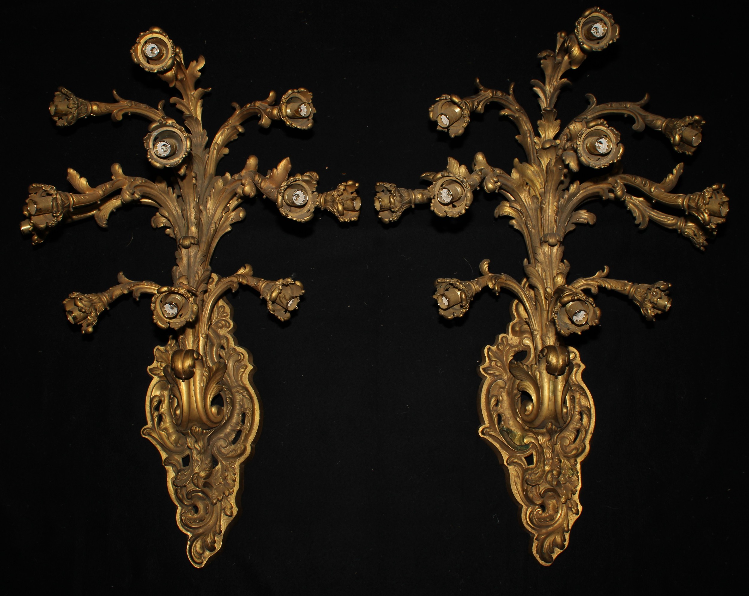 A pair of substantial Louis XV style gilt bronze eleven-light wall sconces, cast in the Rococo taste, 100cm high