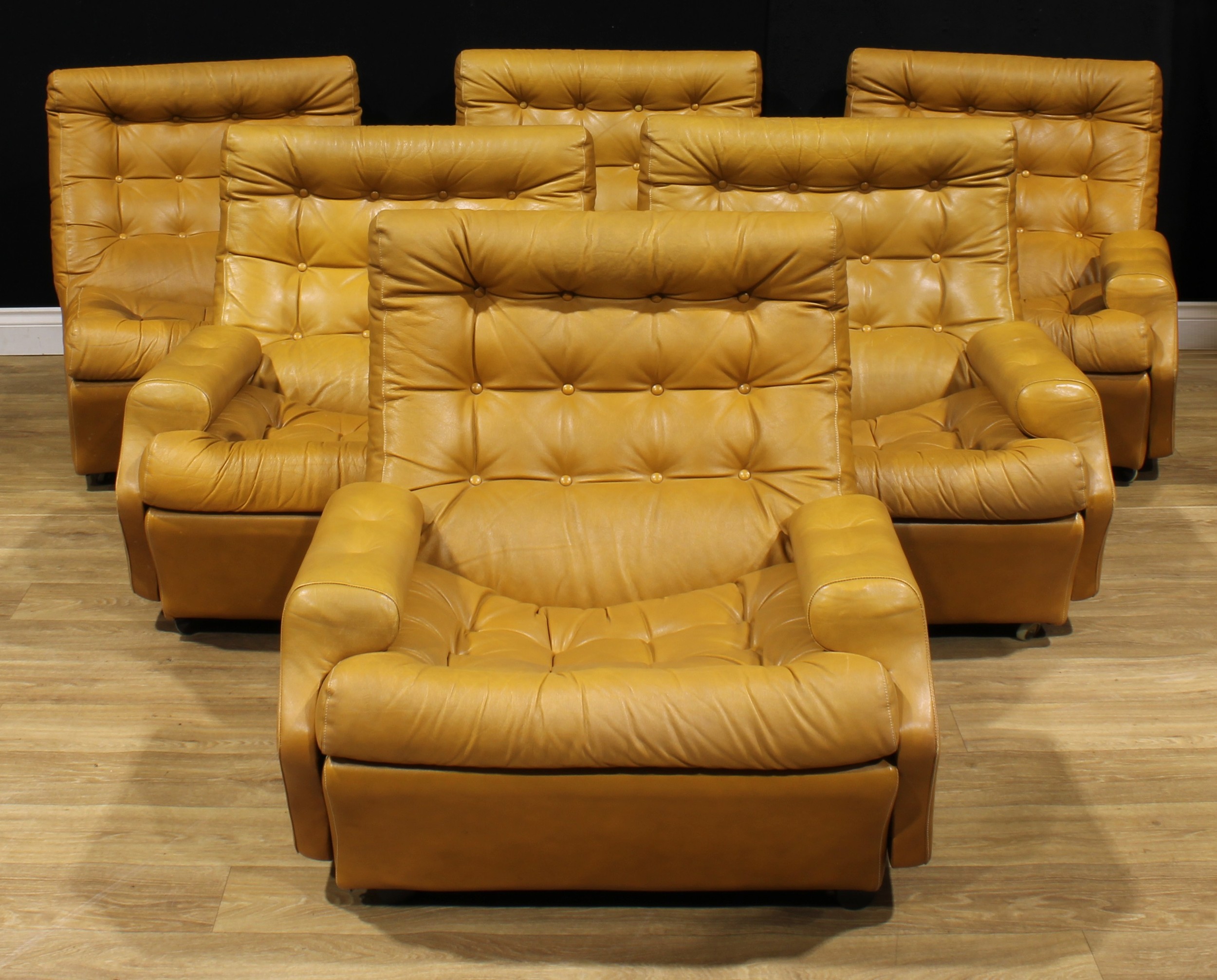 Mid-century Design - a set of six modular lounge chairs, in the manner of Ebbe Gehl & Søren Nissen, comprising four armchairs and a pair of easy chairs, the four with removable arms for sofa transformation, 78.5cm high, 82cm reducing to 69cm wide, the seat 50cm wide and 54cm deep, c.1975  NB - This lot is offered for sale as a work of art, the cushions may not comply with the Furniture and Furnishings (Fire) Safety Regulations 1988 and for this reason should not be used in a private dwelling.