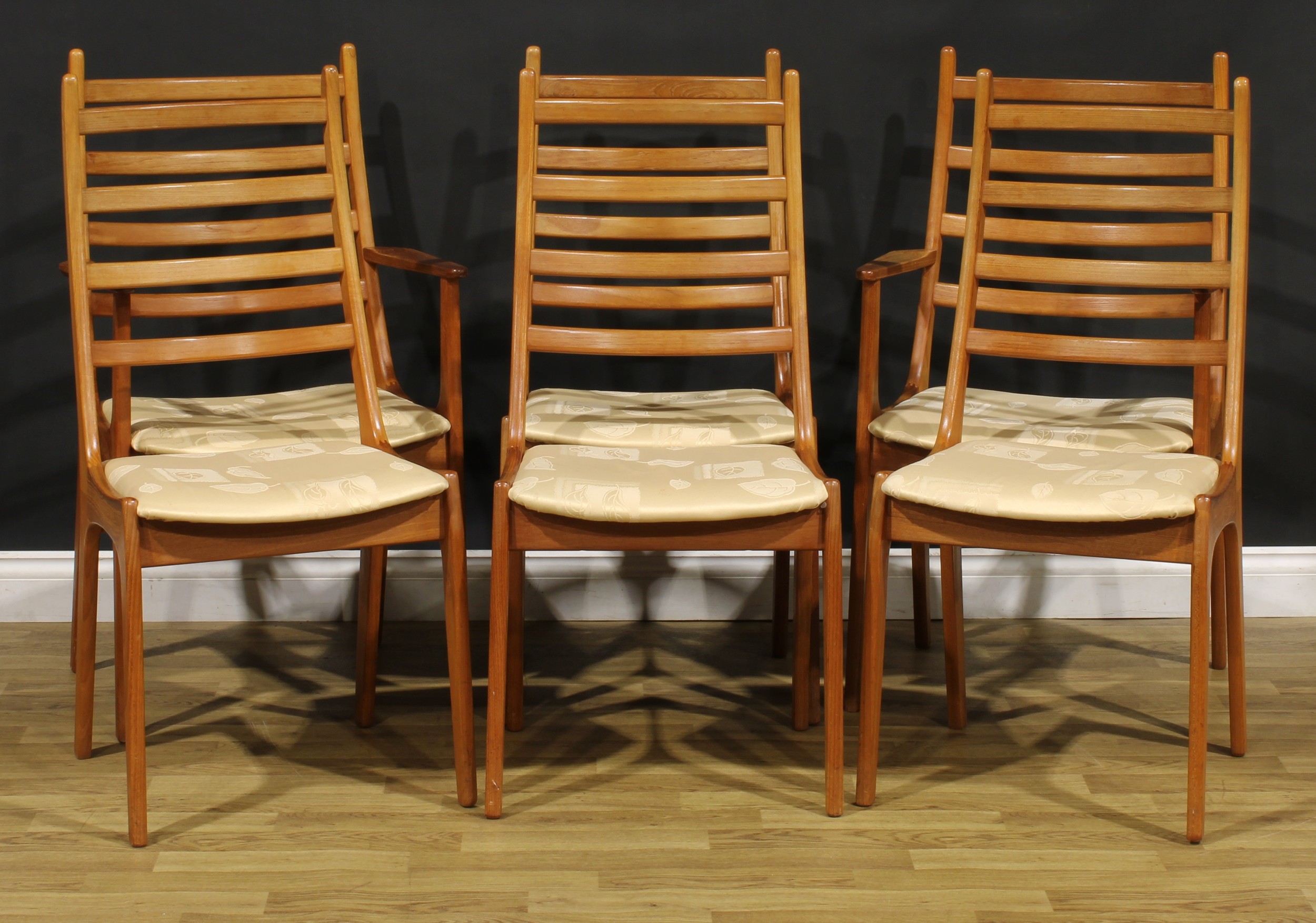 Mid-century Design - a set of six Danish teak dining chairs, by Korup Stolefabrik, probably designed by Kai Kristiansen or Henning Kjaernulf, comprising four side chairs and a pair of carvers, the side chair 99cm high, 47cm wide, the seat 36cm deep, the carver 99cm high, 56cm wide, the seat 47cm wide and 37cm deep, c.1965  NB - This lot is offered for sale as a work of art, the cushions may not comply with the Furniture and Furnishings (Fire) Safety Regulations 1988 and for this reason should not be used in a private dwelling.
