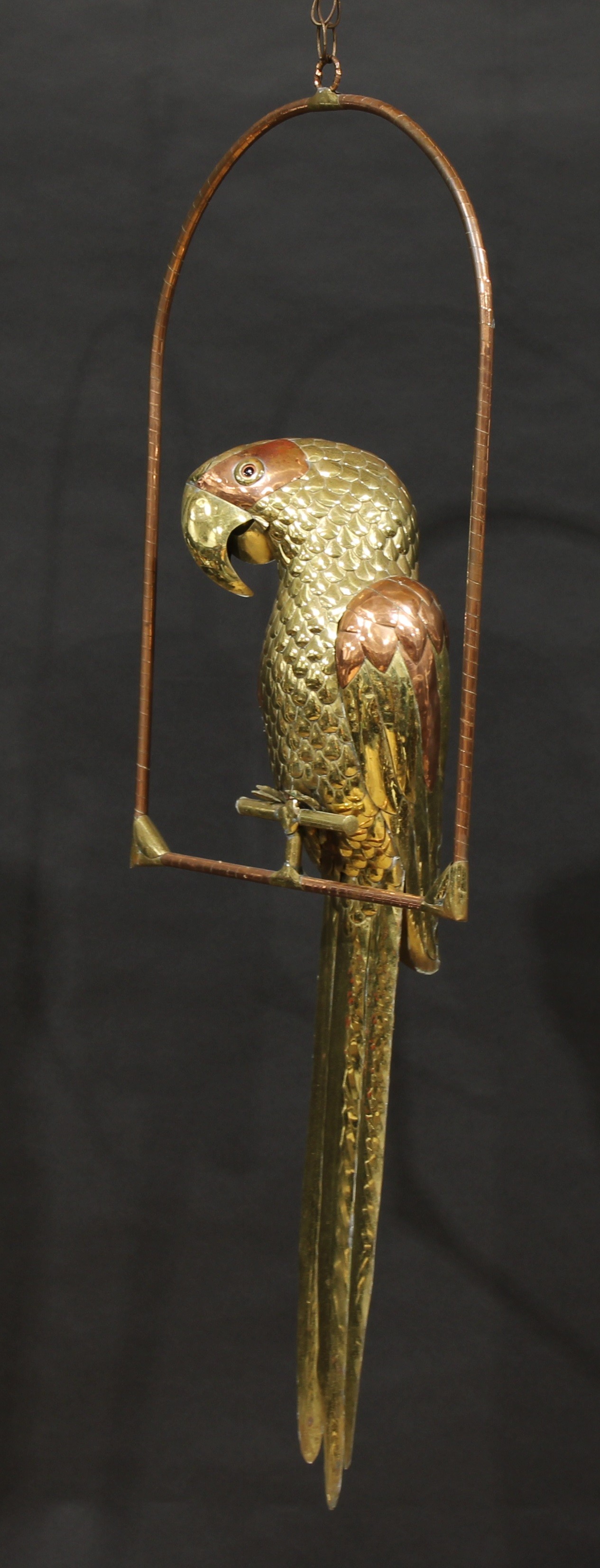 Sergio Bustamante (Mexican, bn. 1949), a large brass and copper sculpture, parrot on perch, 131cm high overall, 51.5cm wide