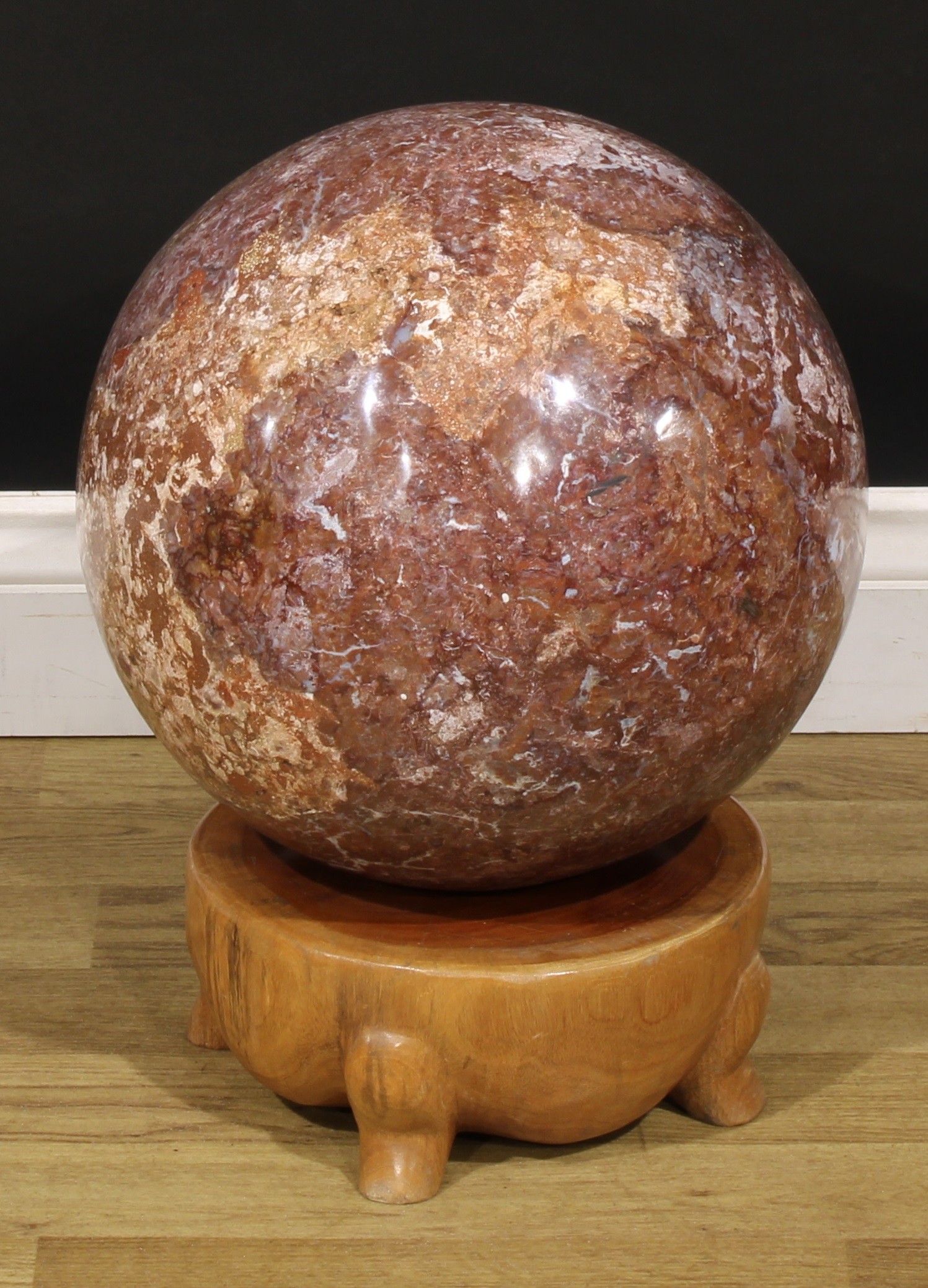Geology - a large brecciated jasper sphere, 32cm diameter, 49kg, mounted for display on hardwood stand