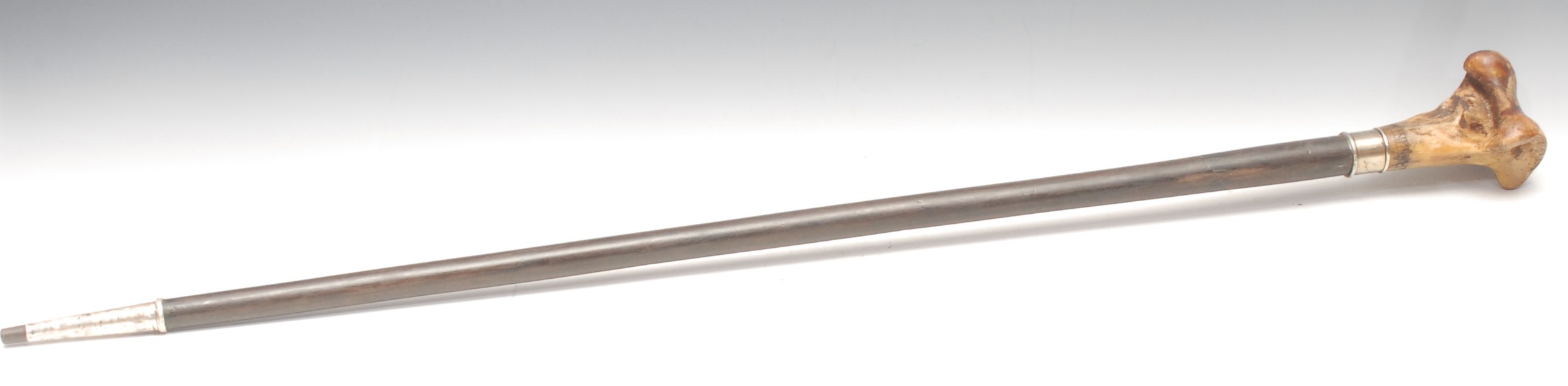 Mysticism & The Occult - a walking stick, the handle a mounted section of bone scrimshaw engraved with a pentagram and a band of inscription, hardwood cane, 95cm long