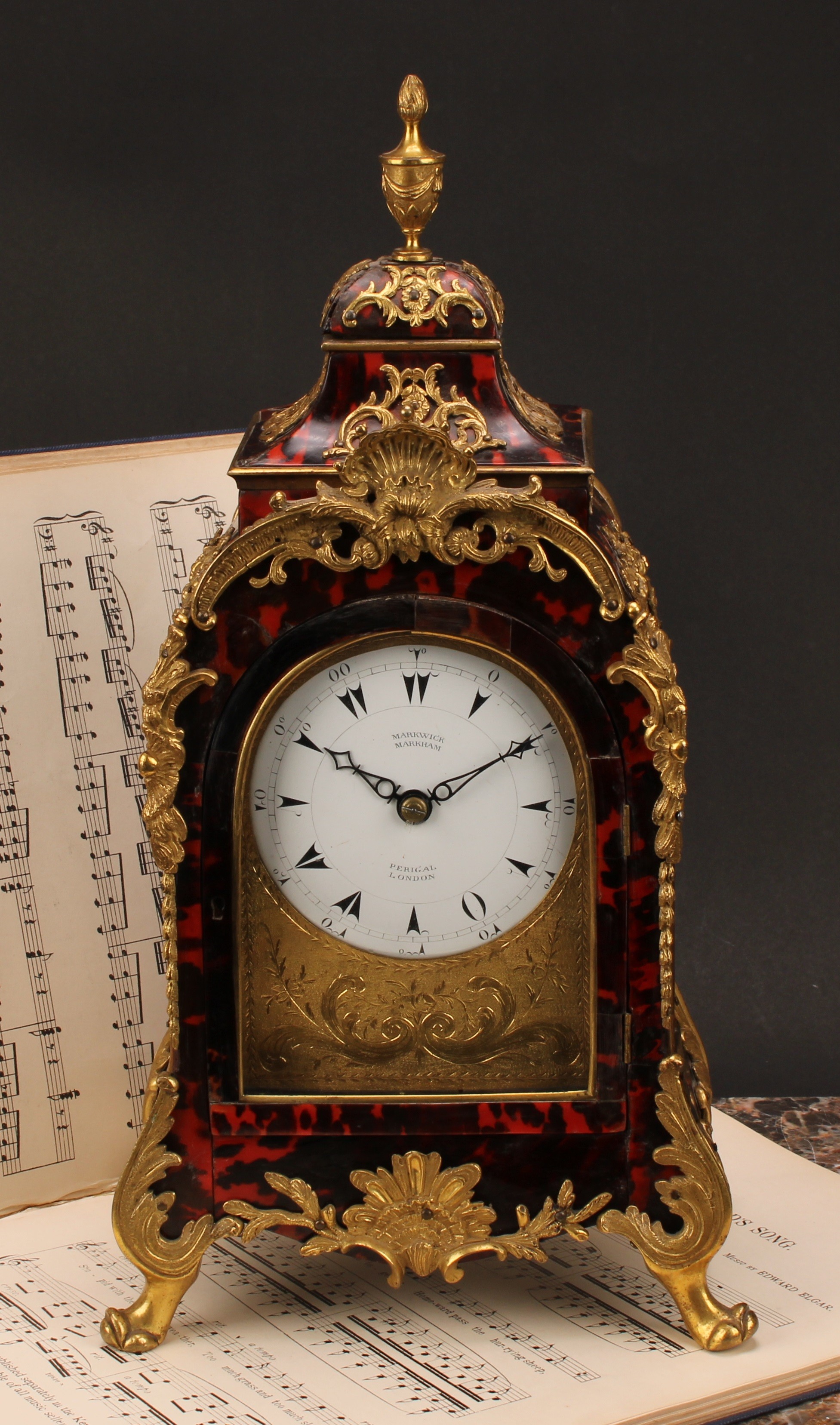 A George III gilt metal mounted tortoiseshell musical table clock, for the Turkish market, 10cm enamel dial inscribed MARKWICK MARKHAM PERIGAL LONDON, Turkish numerals, eight day movement striking on a nest of eight bells with sixteen hammers, ninth hour-strike bell, engraved backplate inscribed John Barbot London, 39cm high, 20.5cm wide, 14cm deep