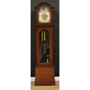 A substantial Edwardian mahogany longcase clock, 33.5cm arched brass dial applied with Arabic numerals, subsidiary seconds dial, rolling moon to arch, Chime/Silent and Whittington chimes/Westminster chimes selectors to upper angles, triple winding holes, eight day movement striking on nine Harringtons’ patent tubular bells, the case with arched glazed door to waist, 227.5cm high, 56cm wide, 32.5cm deep, c.1905