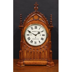 A large late Victorian Gothic Revival architectural wimperg shaped mantel clock, 24.5cm dial inscribed SKARRATT & CO WORCESTER, triple winding holes, eight day fusee movement striking on a nest of eight bells and a gong, 76cm high, 47cm wide, 25.5cm deep, c.1890