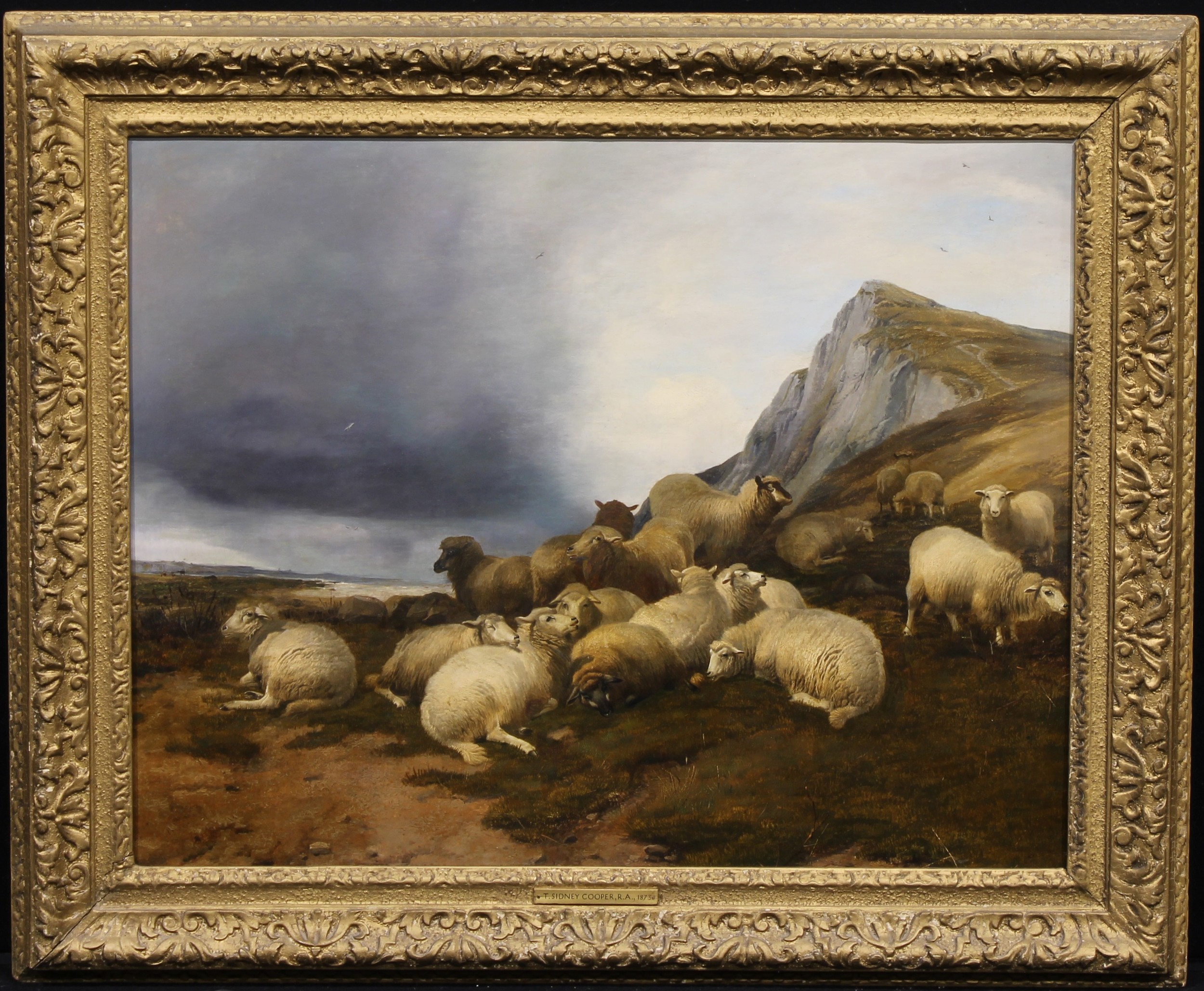 Thomas Sidney Cooper (1803-1902) Sheep in Coastal Landscape, faintly signed, the mount inscribed T. SIDNEY COOPER, R.A., 1873, oil on canvas, 58.5cm x 74.5cm