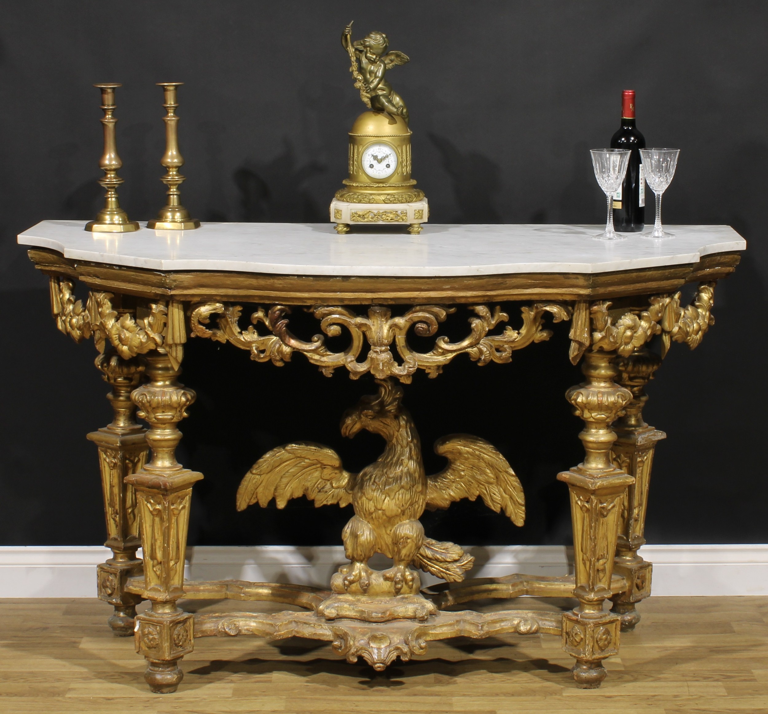 A 19th century giltwood pier table, in the manner of William Kent, shaped serpentine Carrara marble top, the underframe centred by an eagle, 91cm high, 151cm wide, 76cm deep, c.1850