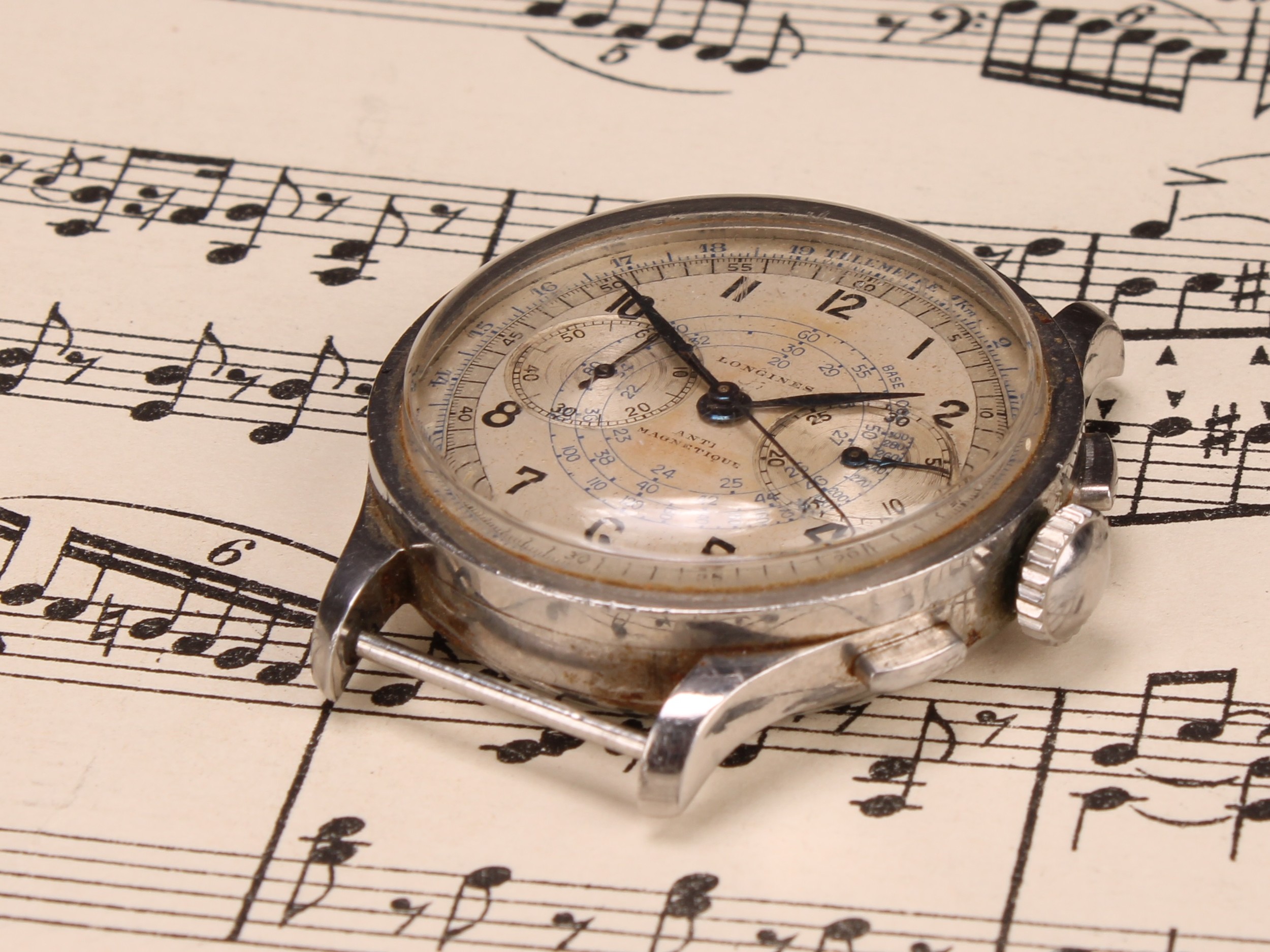 A Longines Telemetre stainless steel chronograph watch, silvered dial with Arabic numerals, pair of subsidiary second/minute dials, centre seconds hand, "Anti-Magnetique", crown and chronometer buttons to side, 4cm diameter overall, c.1940