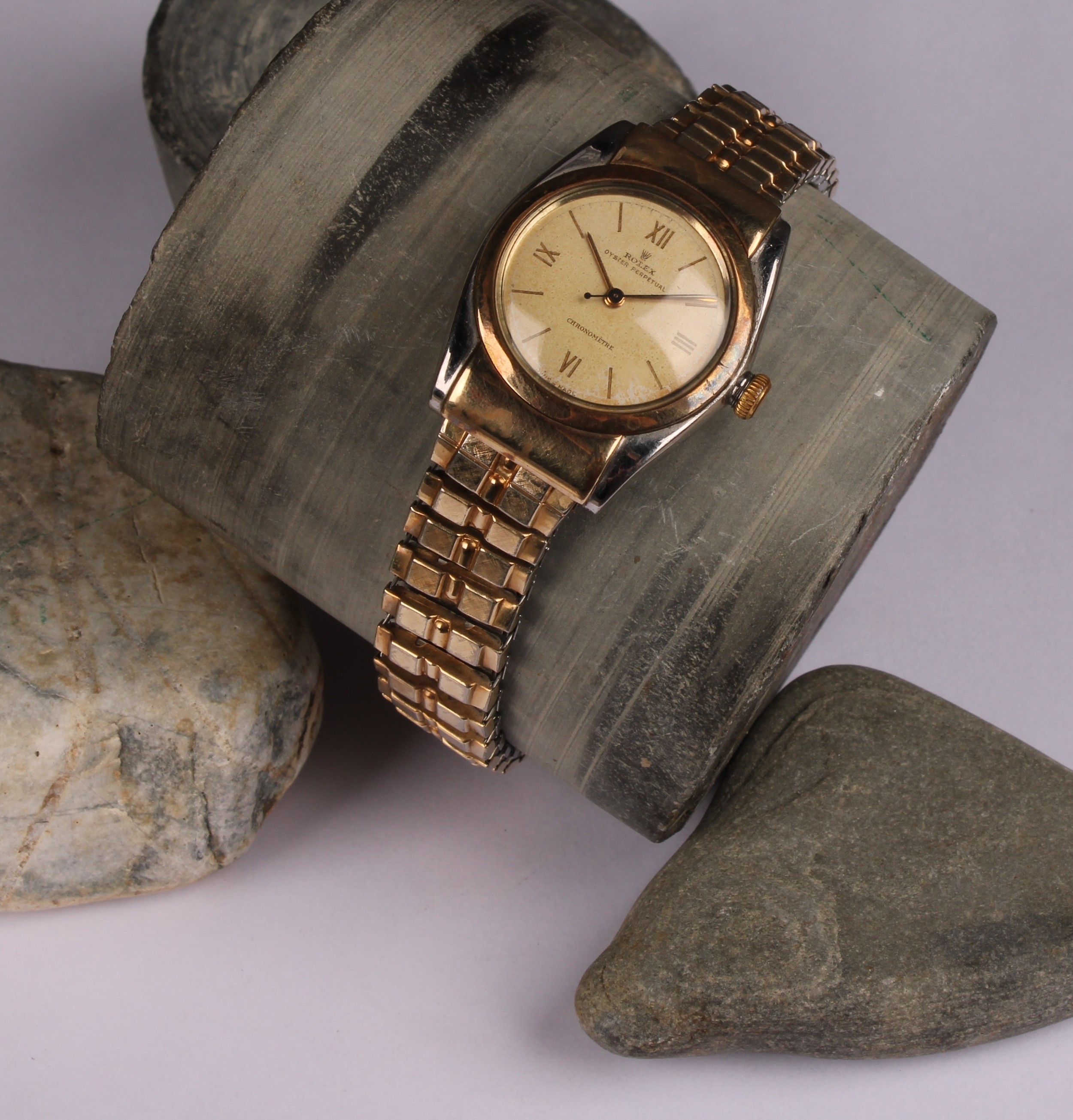 A gentleman's Rolex Oyster Perpetuel Chronometre, gold plated stainless steel, bubble back, Champagne dial baton indicators with Roman numerals to quarters, centre seconds hand, Rolex Oyster winder, integral expanding bracelet strap, with box