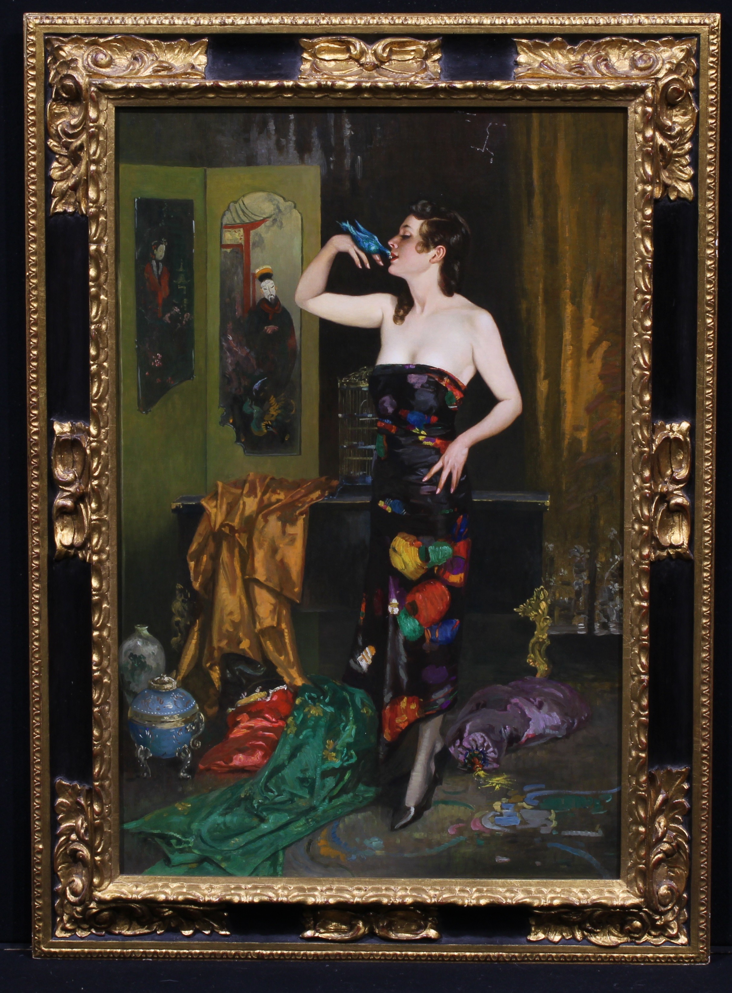 Attributed to William Henry Margetson (1861-1940) A Lady of Fashion in a Chinoiserie Boudoir, Frost & Reed label to verso inscribed in pencil, oil on canvas, 89cm x 58cm