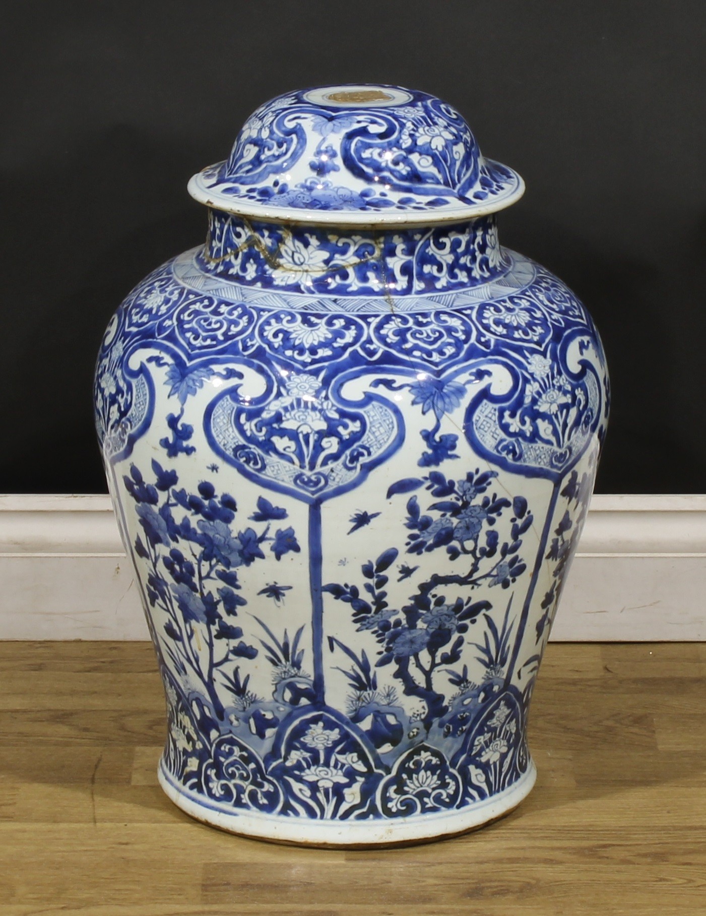 A Chinese baluster temple jar and cover, decorated in tones of underglaze blue with panels of flowers, foliage and insects, 53cm high, 17th/18th century