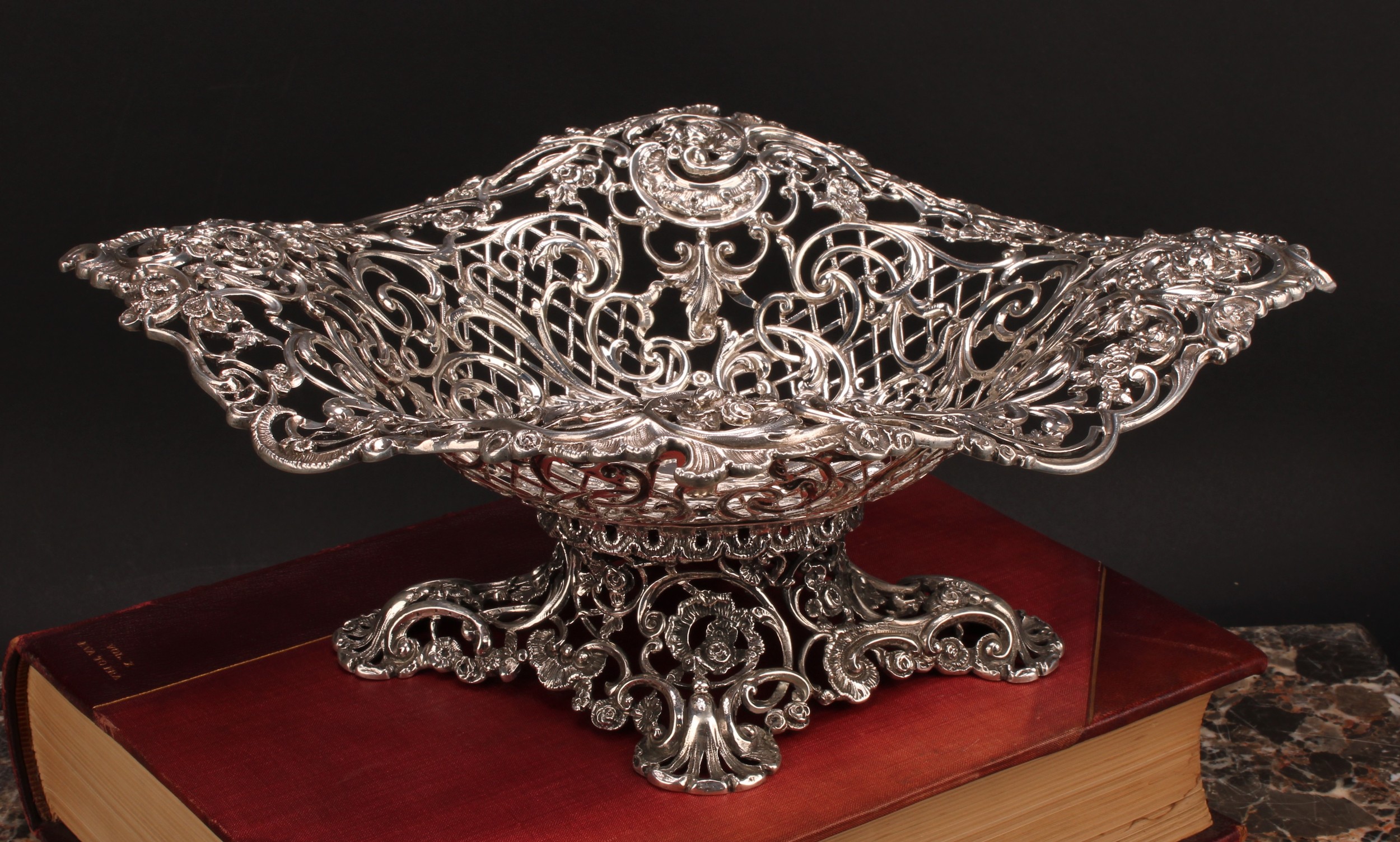A Victorian cast silver table centre pedestal dish, pierced and modelled with a with flowers, scrolling leaves, and trellis, 37cm wide, Goldsmiths & Silversmiths Company, London 1893, 1248g