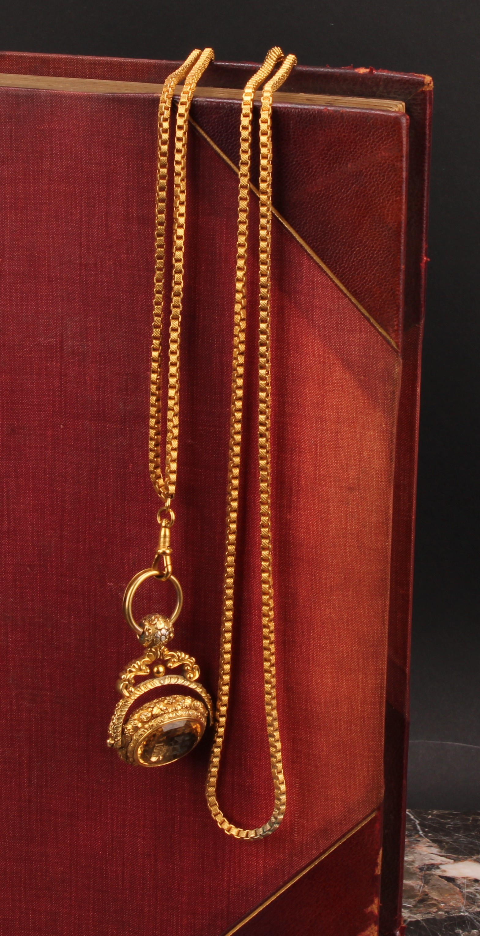A 19th century gilt metal swivel fob seal, citrine and chalcedony matrices intaglio engraved with armorials, 4cm wide, gilt metal chain